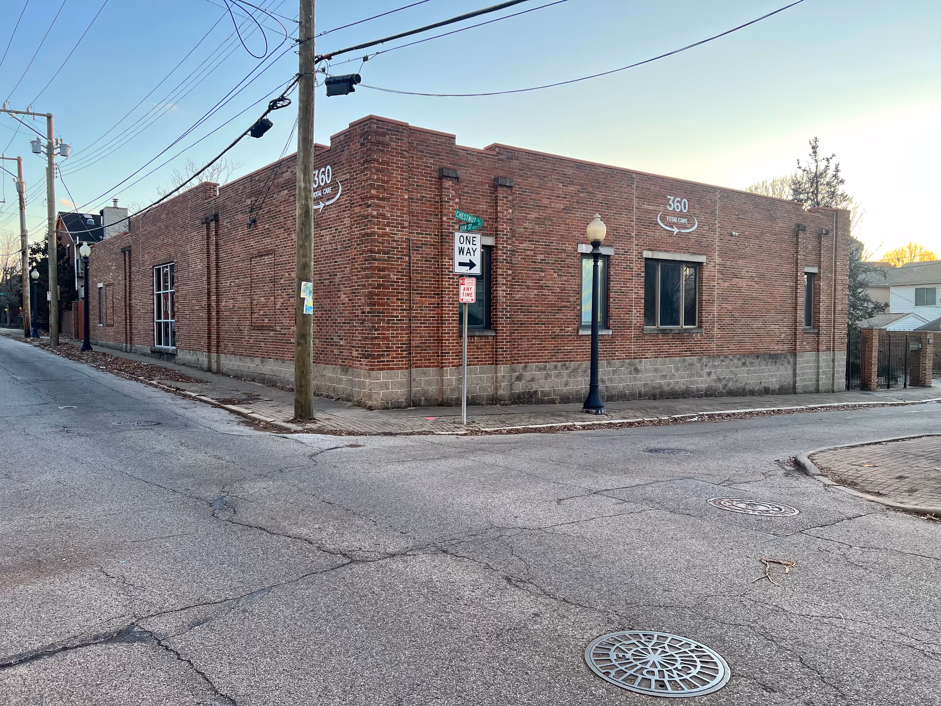 Brick 360 Total Care facility on a street corner with power lines and a lamp post.