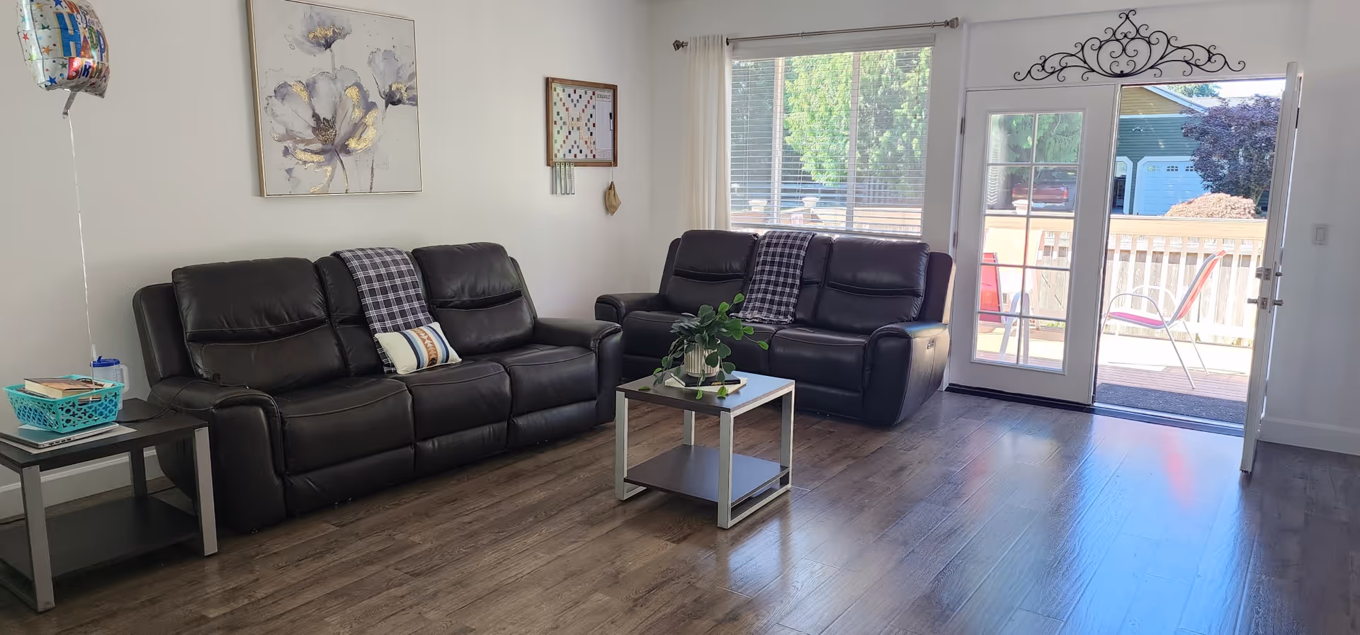 Leather couches arranged in a living room with a coffee table and sliding glass doors