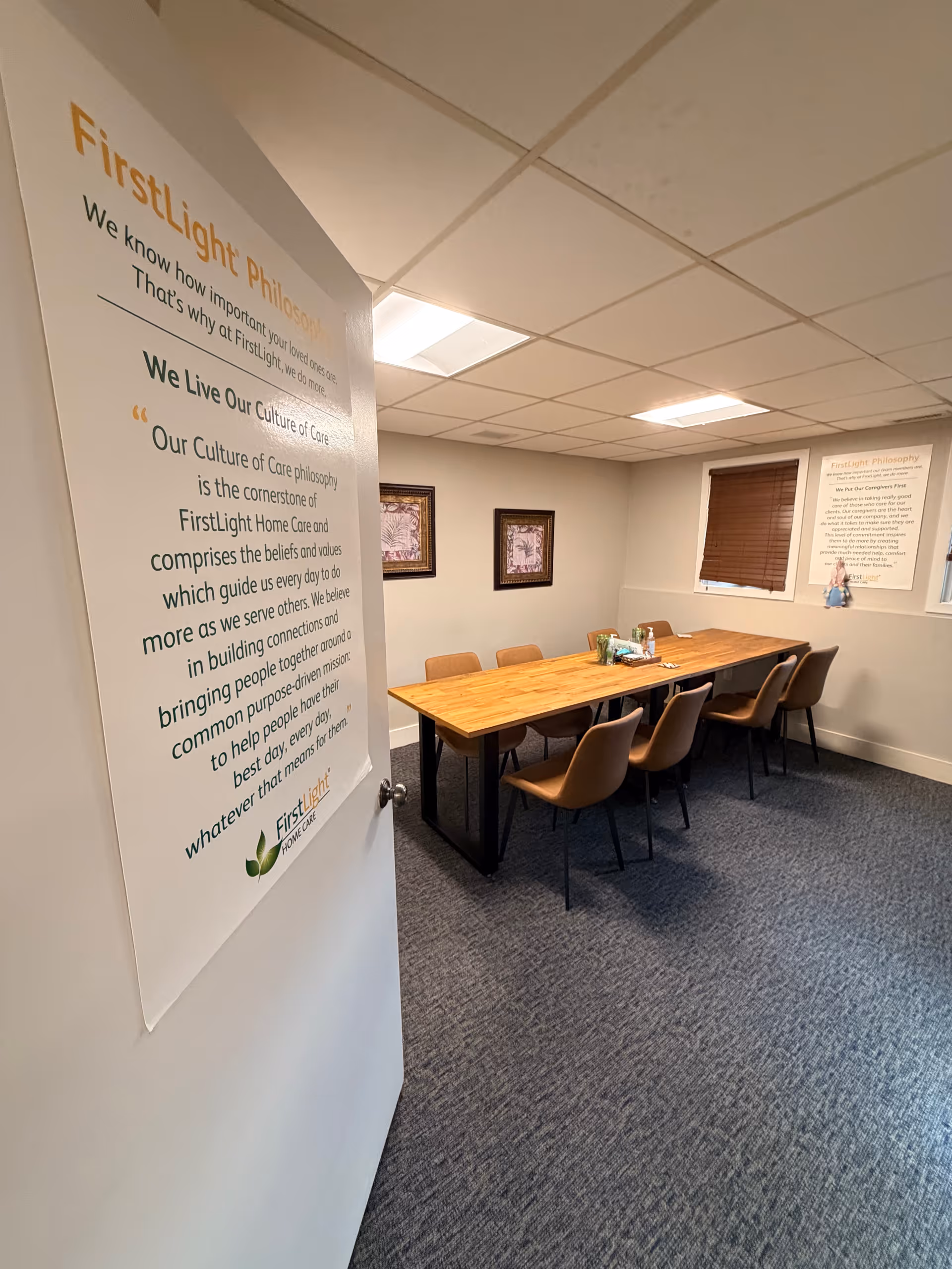 Interior meeting area with long wooden table and chairs at FirstLight Home Care of Boston Northwest
