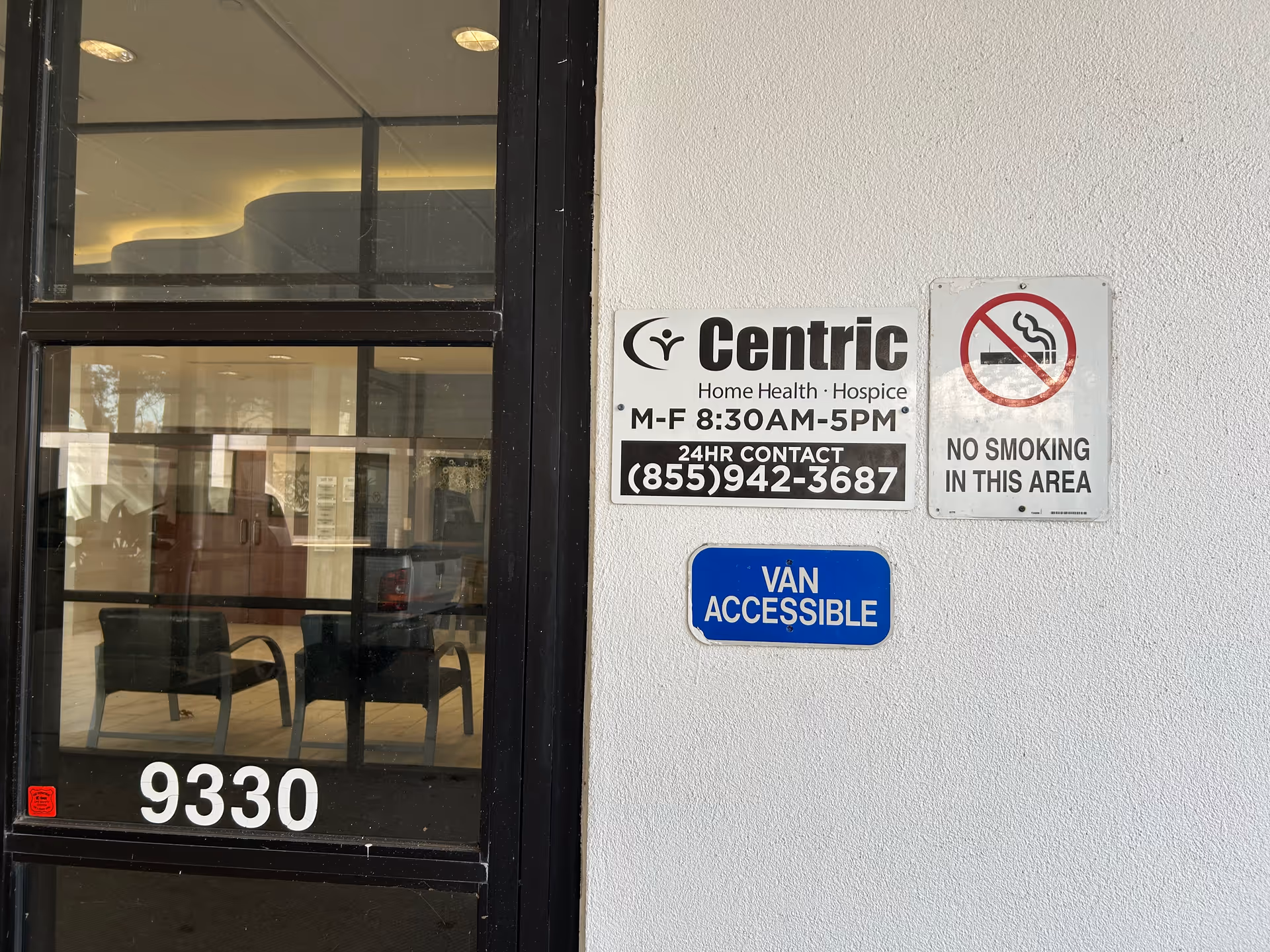 Front entrance of Centric Home Health and Hospice with glass doors and signs.