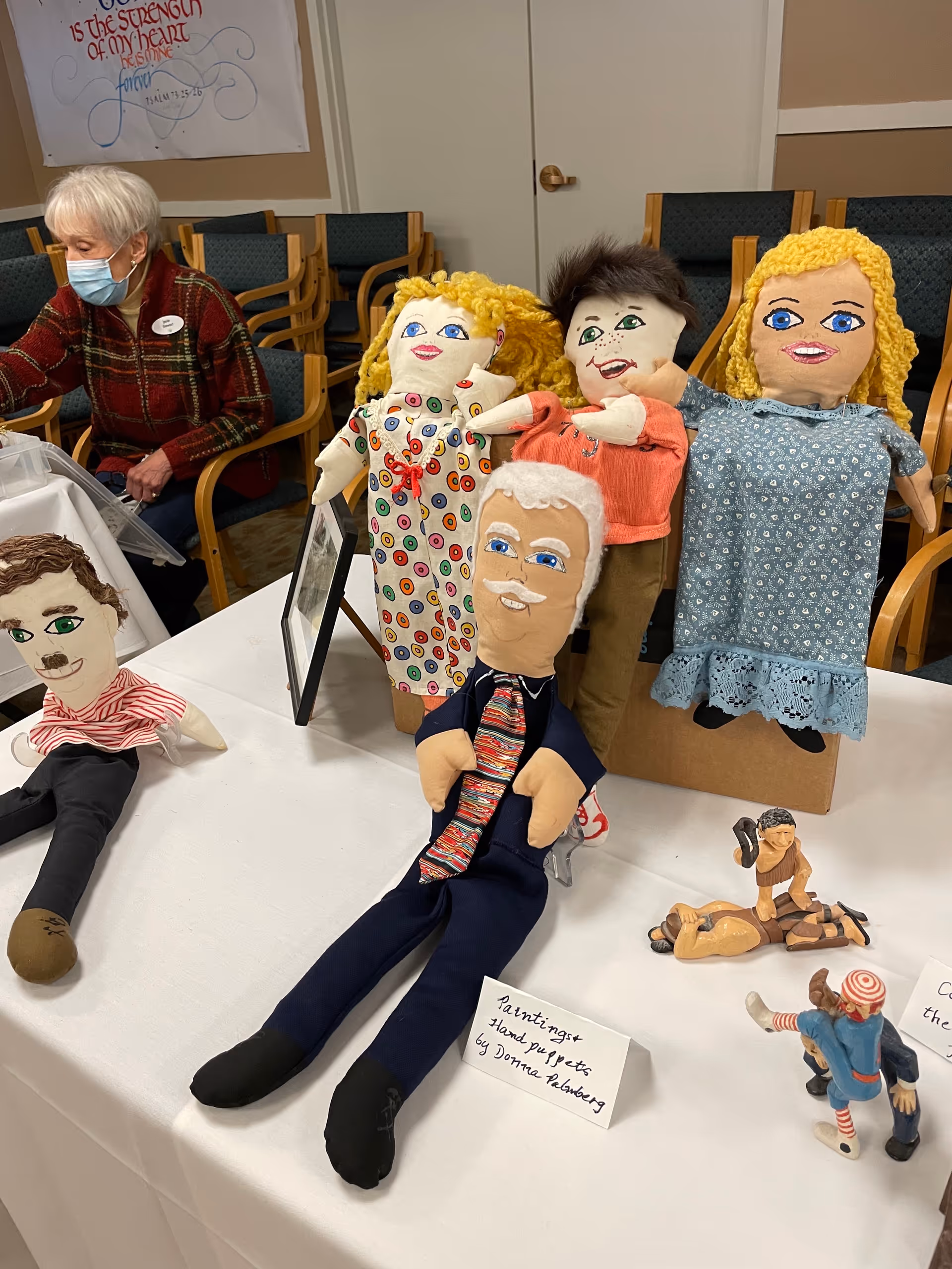 Colorful hand puppets arranged on a table during a crafts activity at Covenant Shores Health Center.