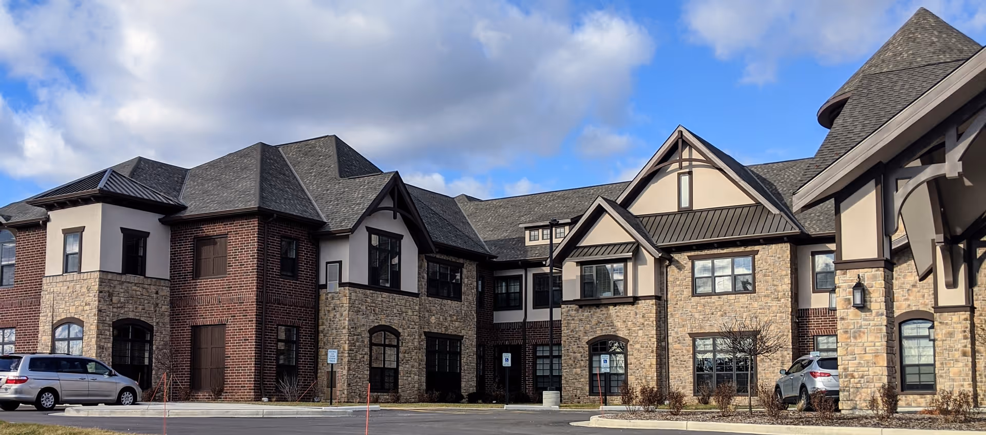 Exterior view of Discovery Commons Brookfield building with stone and brick facade.