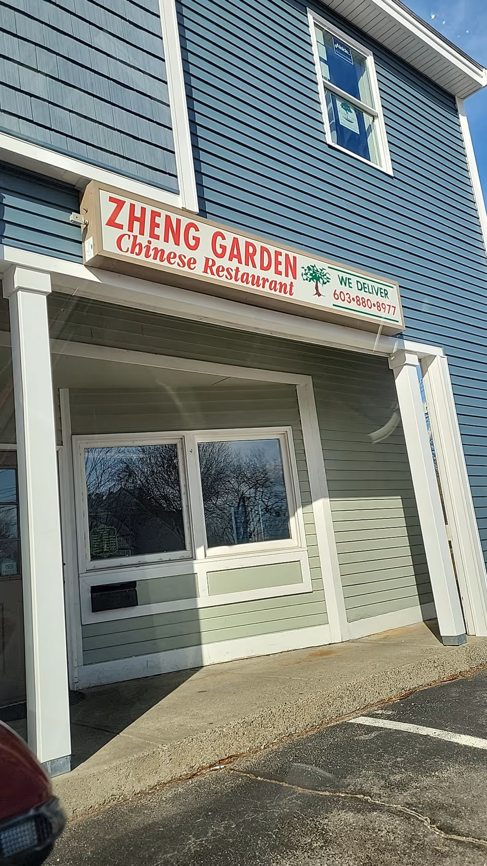 Blue storefront with Zheng Garden Chinese Restaurant sign and entrance.