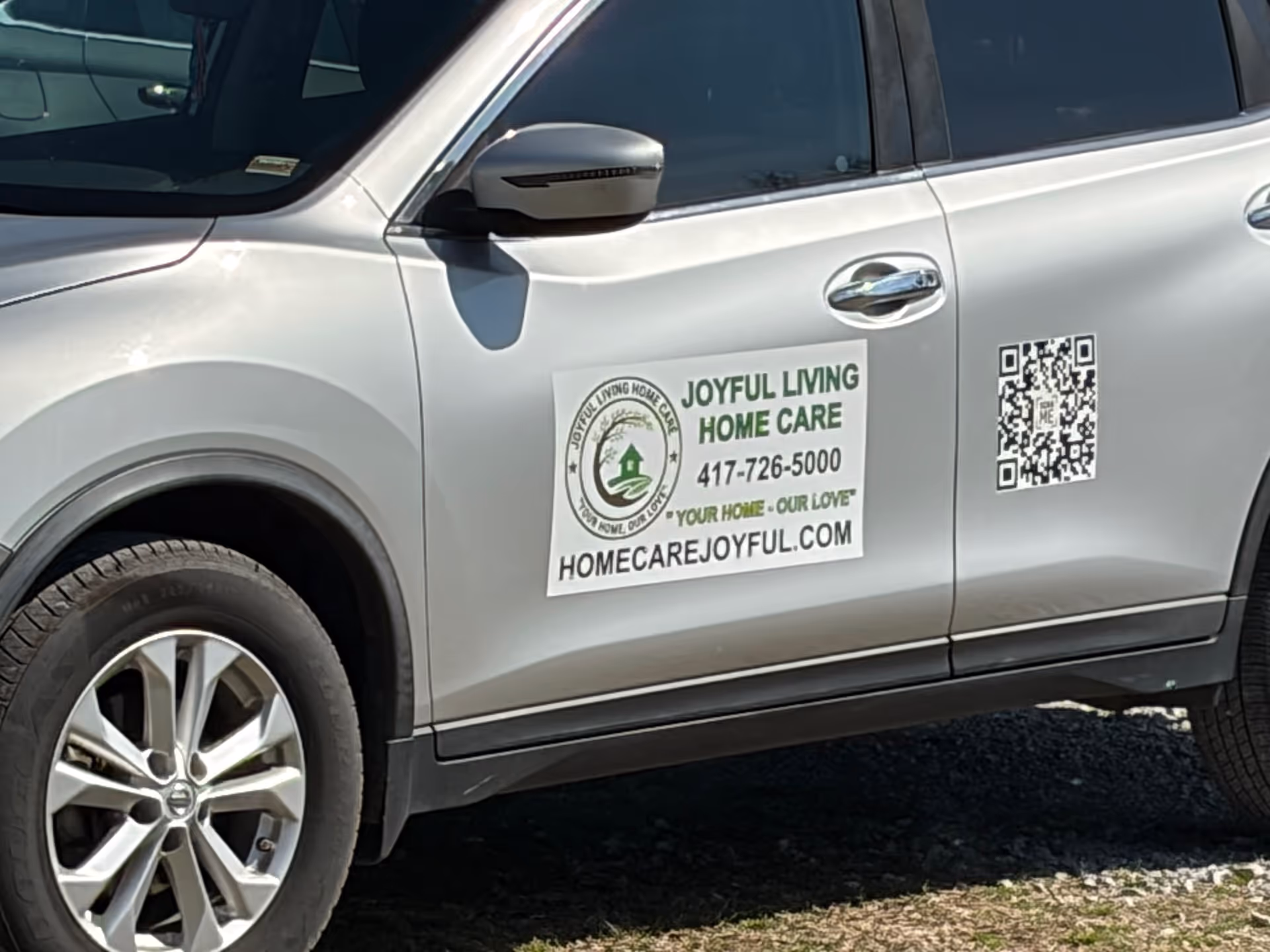 Silver SUV side with Joyful Living Home Care decal, QR code, and contact info.