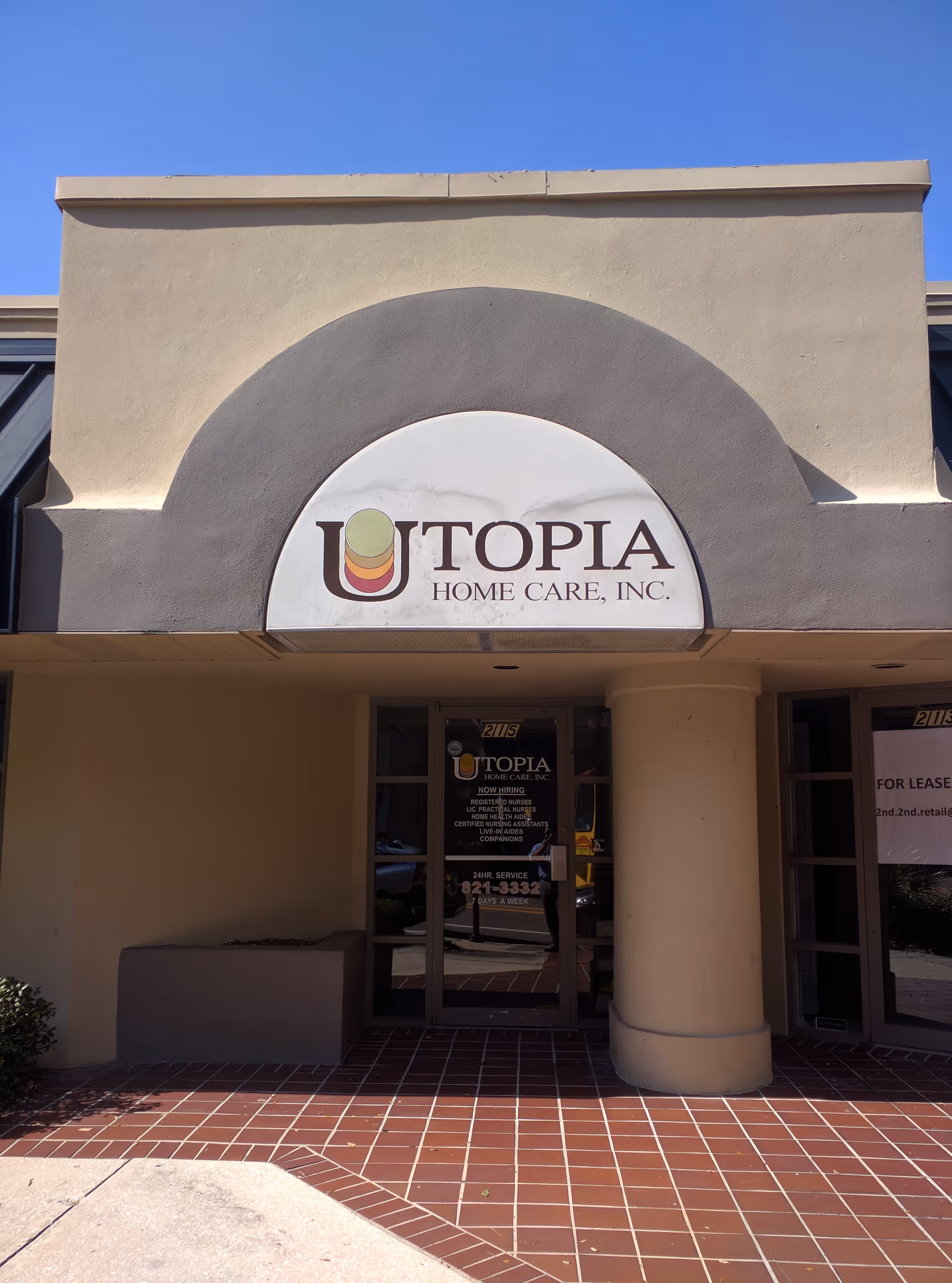 Exterior view of Utopia Home Care, Inc. entrance with arched sign on the facade.