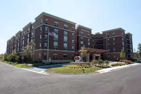Exterior view of Victory Centre of Vernon Hills, senior living building with entrance and landscaping.