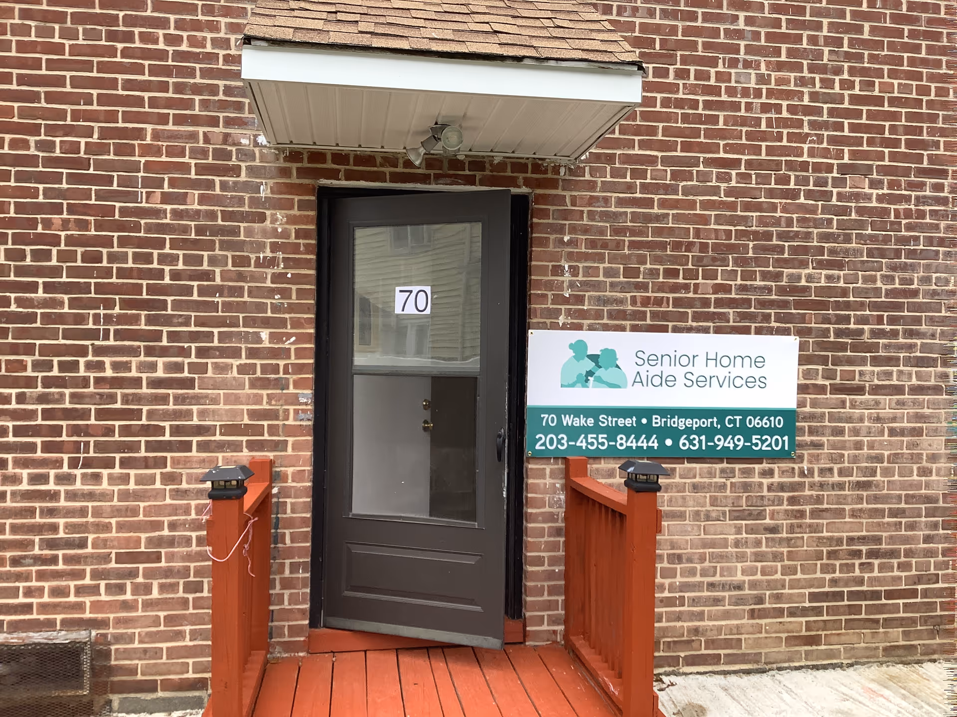 Brick exterior of Senior Home Aide Services with a door and sign