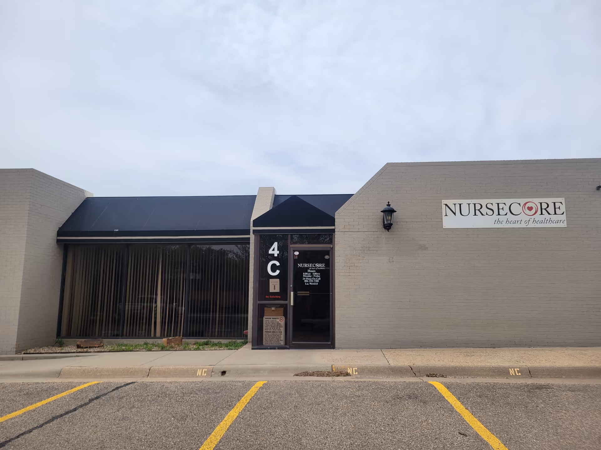 Exterior view of NurseCore Amarillo building entrance with sign and parking lot