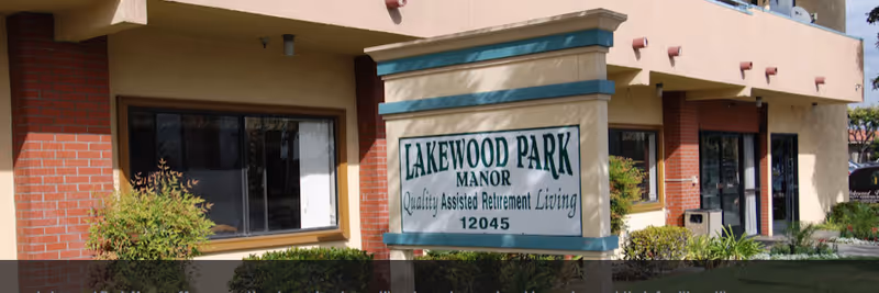 Exterior view of Lakewood Park Manor with sign and landscaped front