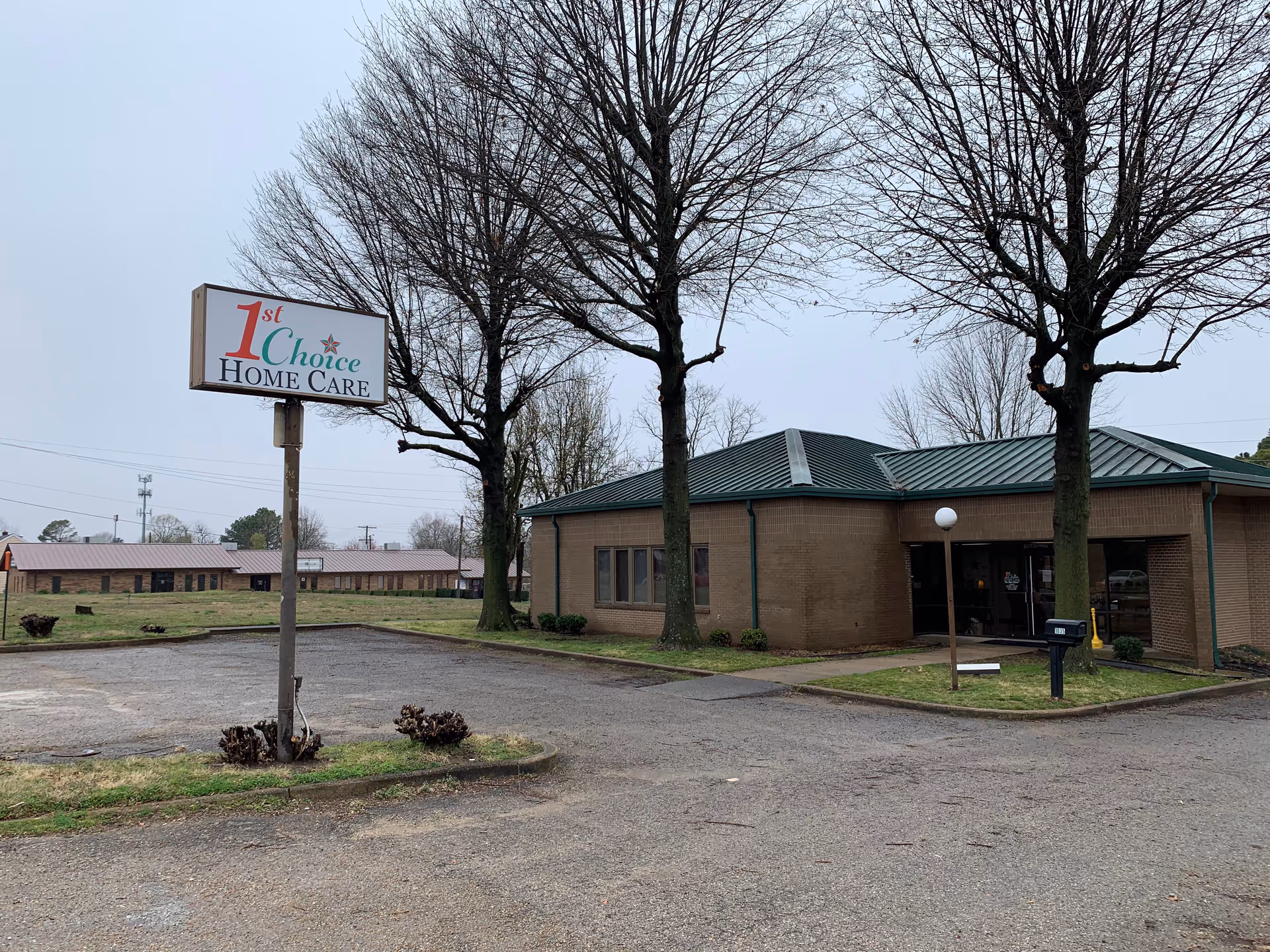 Exterior view of a brick building with a sign reading '1st Choice Home Care'.