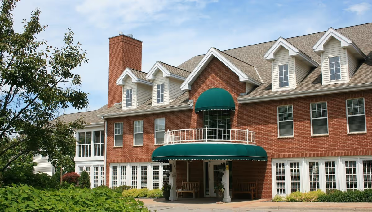 Meridian Manor exterior: red brick building with a green awning entrance.