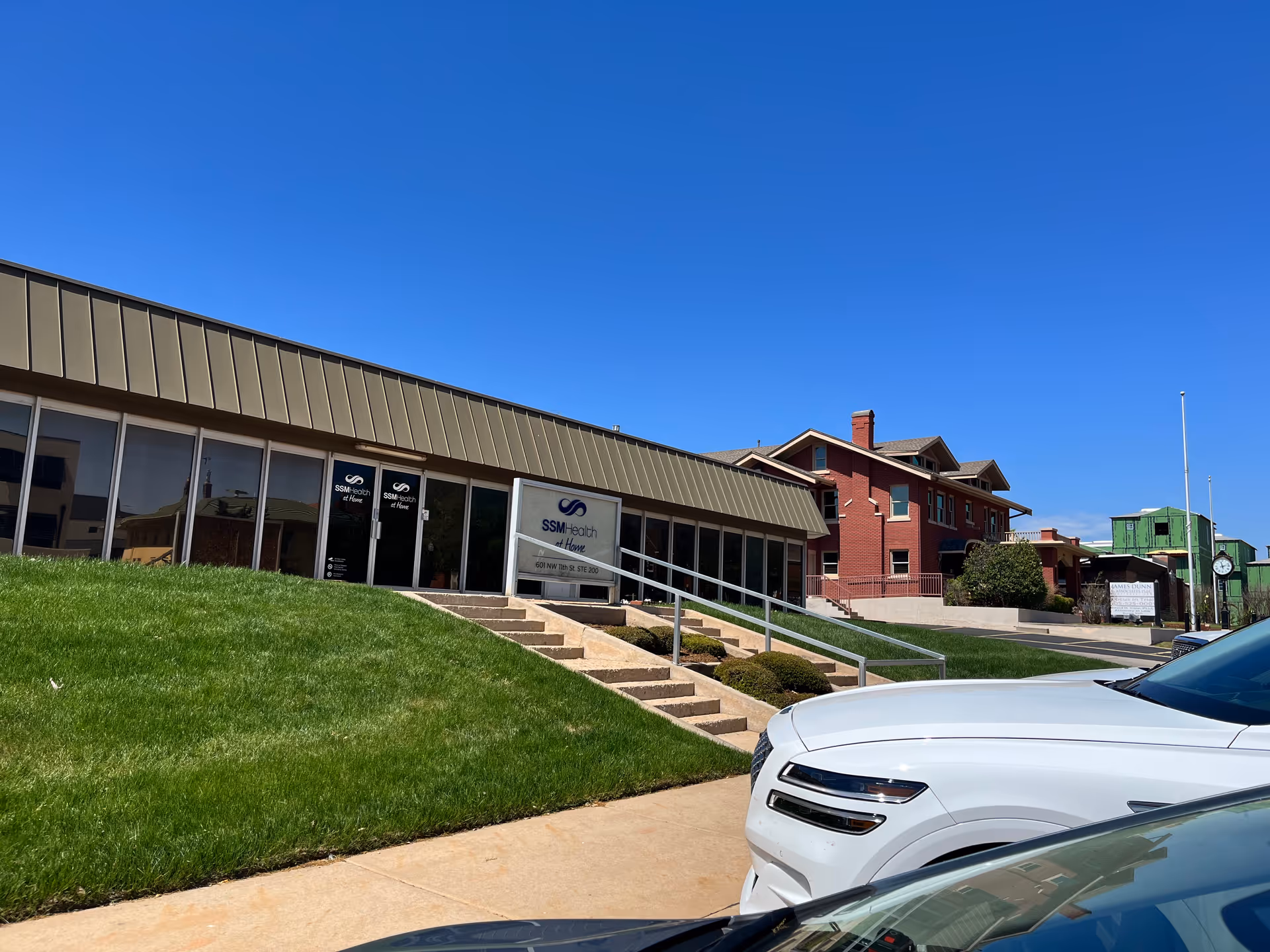 Exterior view of SSM Health at Home storefront with steps, ramp, and lawn.