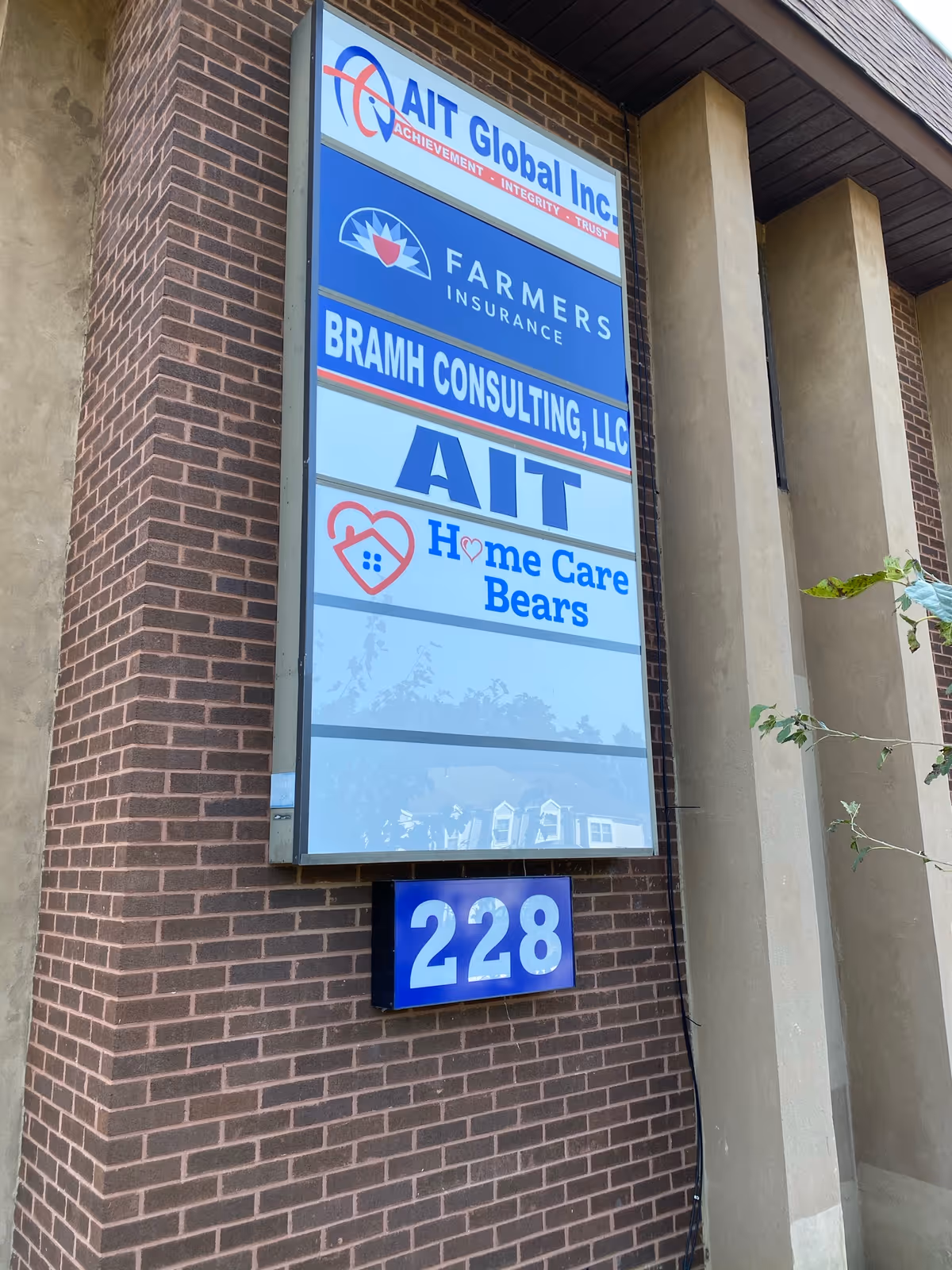 Exterior building signboard displays multiple business names, including Home Care Bears, and the address 228.