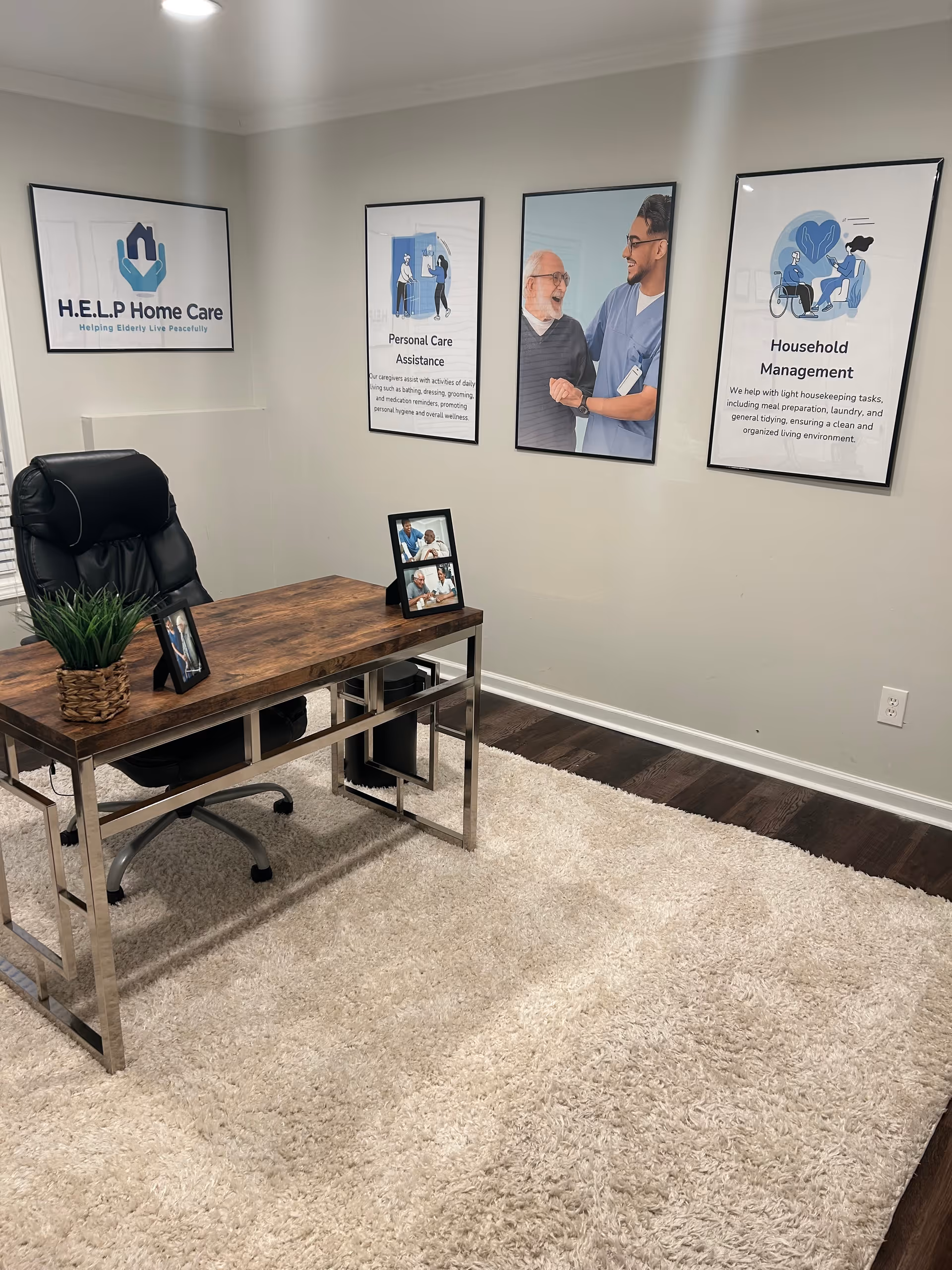 Help Home Care LLC office with wooden desk, chair, plant, and framed wall posters.