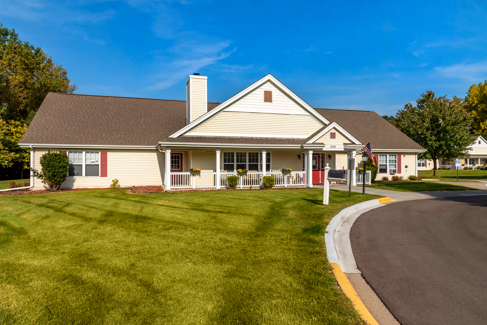 Brookdale West St. Paul senior living facility front view with lawn, porch, and curved road.