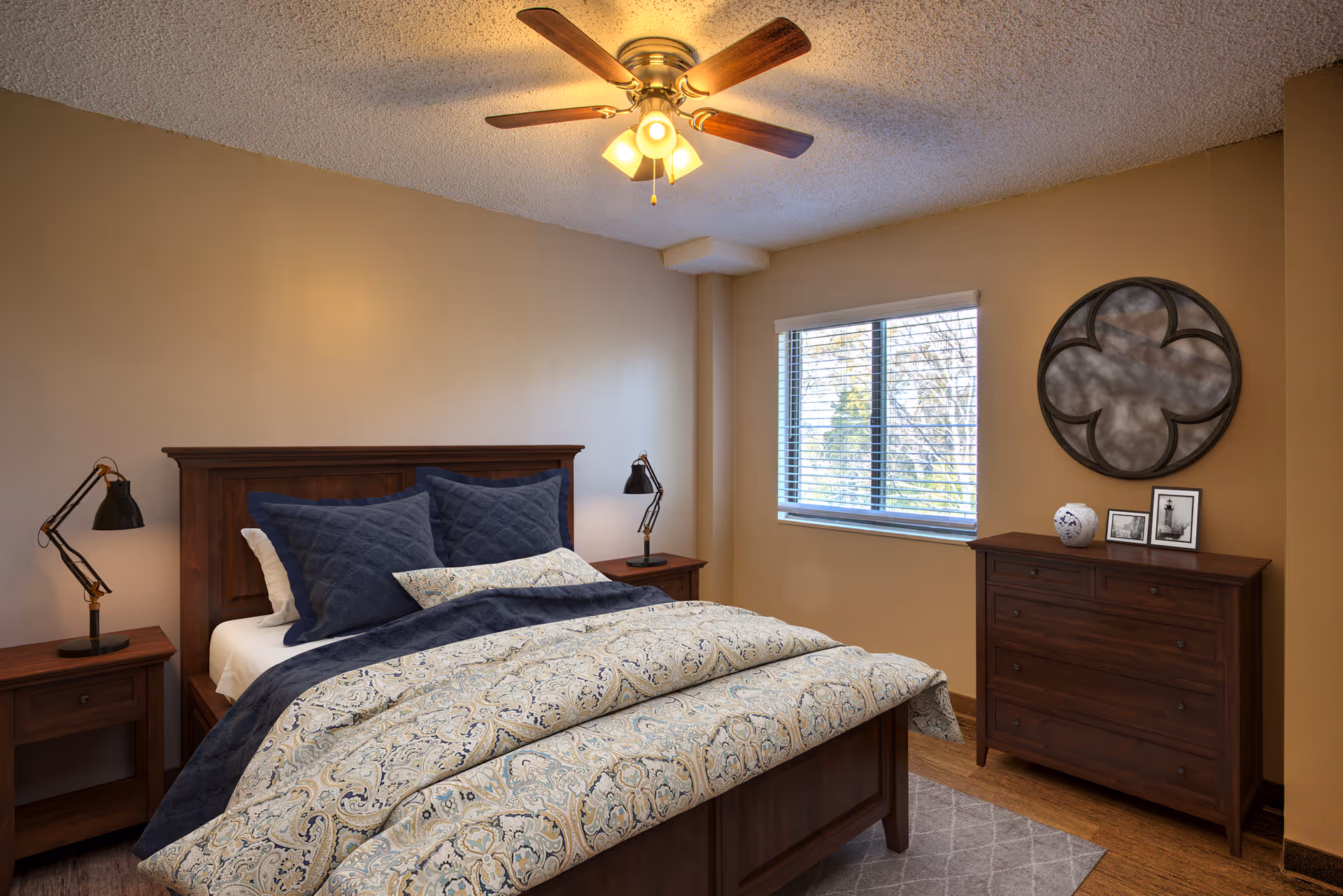 Cozy senior living bedroom with wooden bed, matching dressers, and a window.