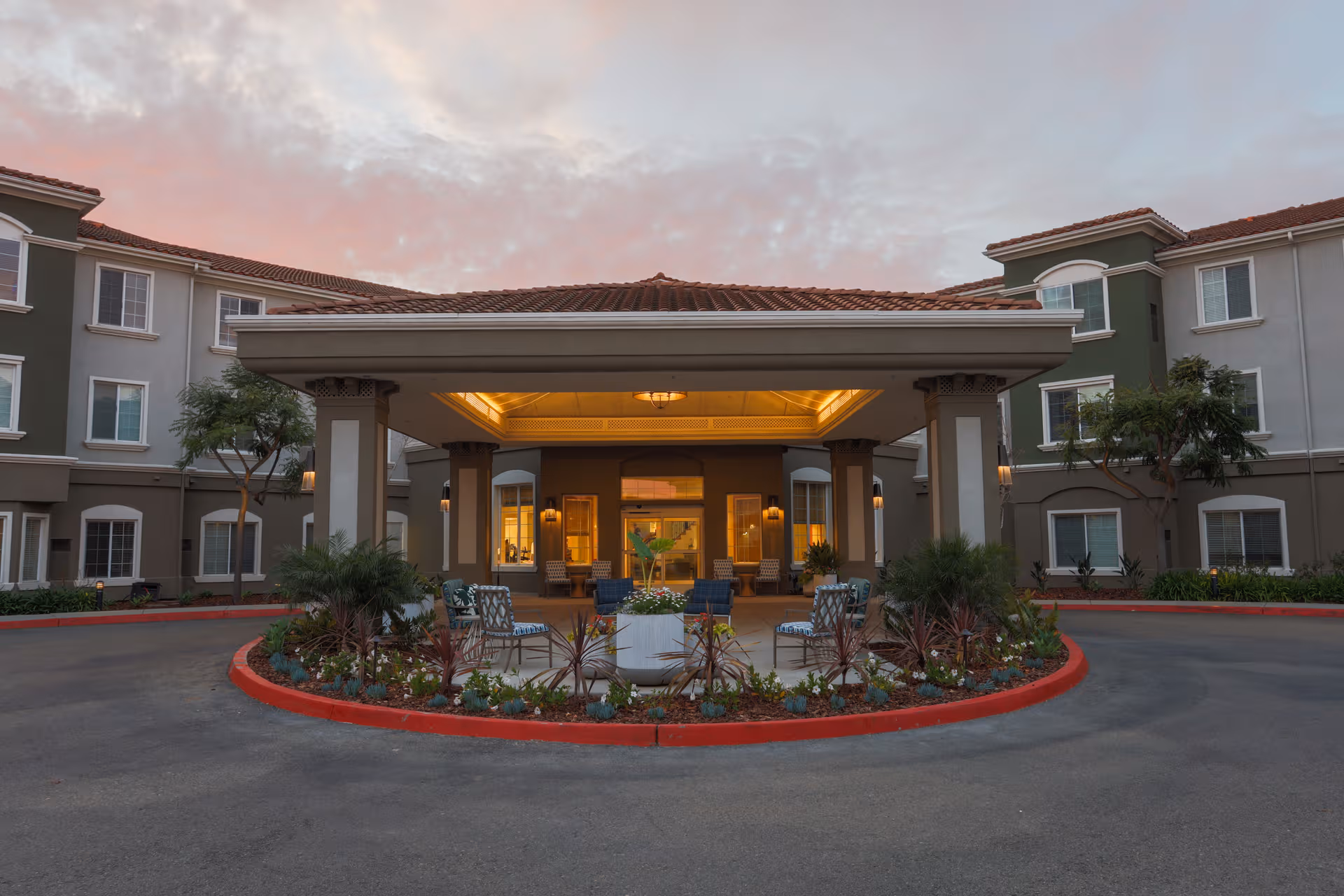 Exterior view of a senior living facility entrance with a circular driveway.