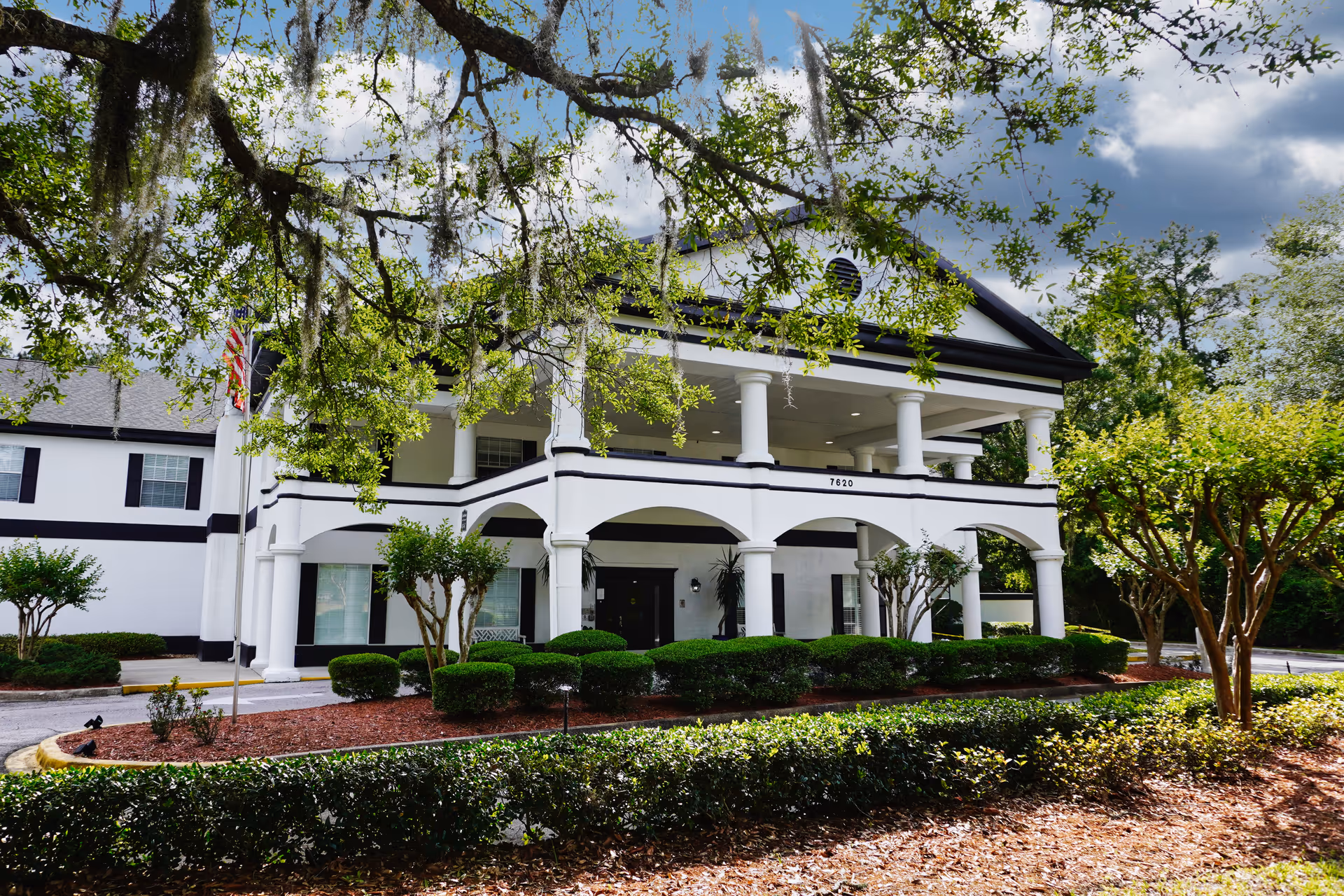 White Sodalis Jacksonville facility with columns, manicured shrubs, and a front entrance.