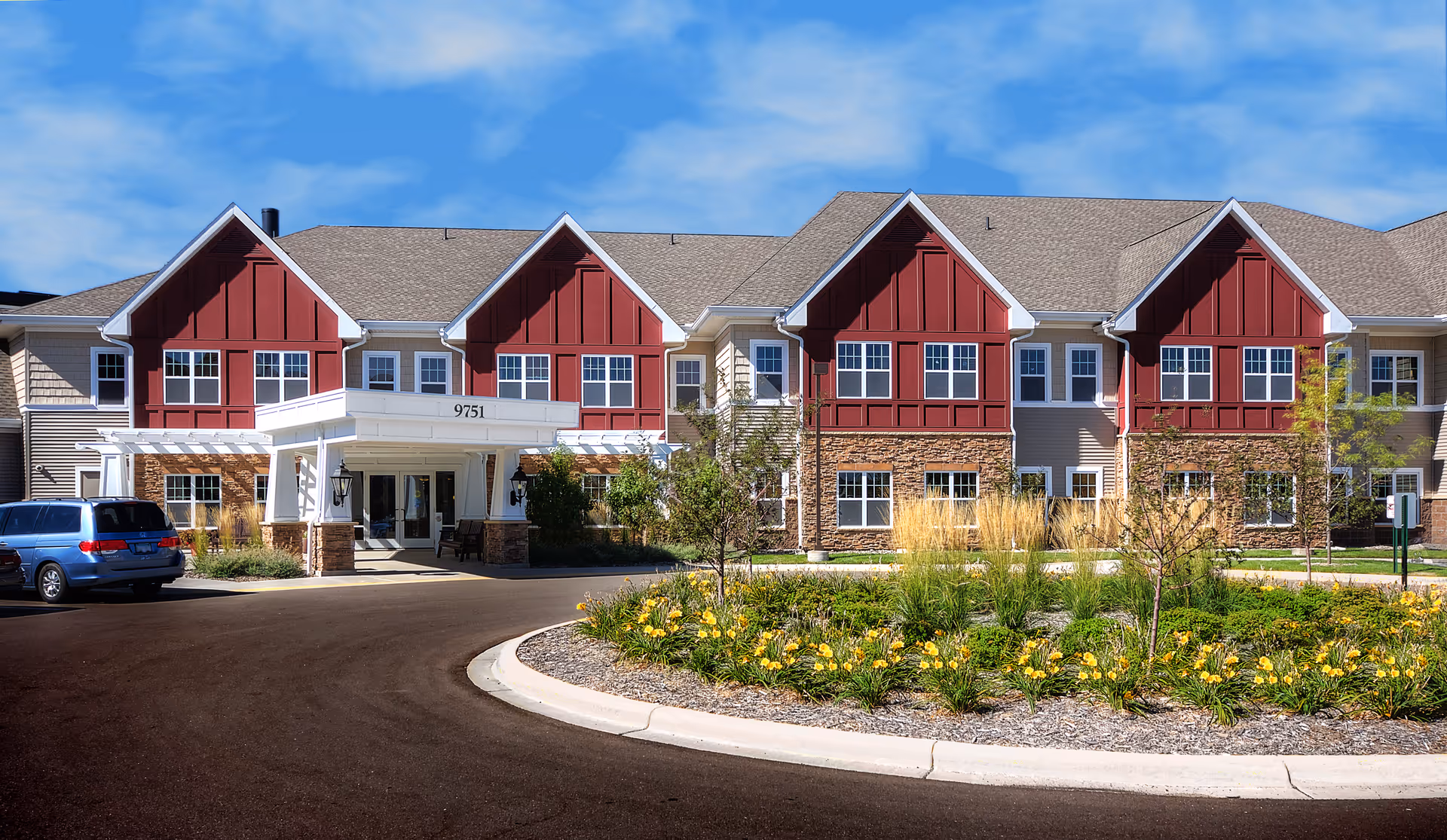 Exterior view of Saint Therese Senior Living of Oxbow Lake with a red-gabled facade.