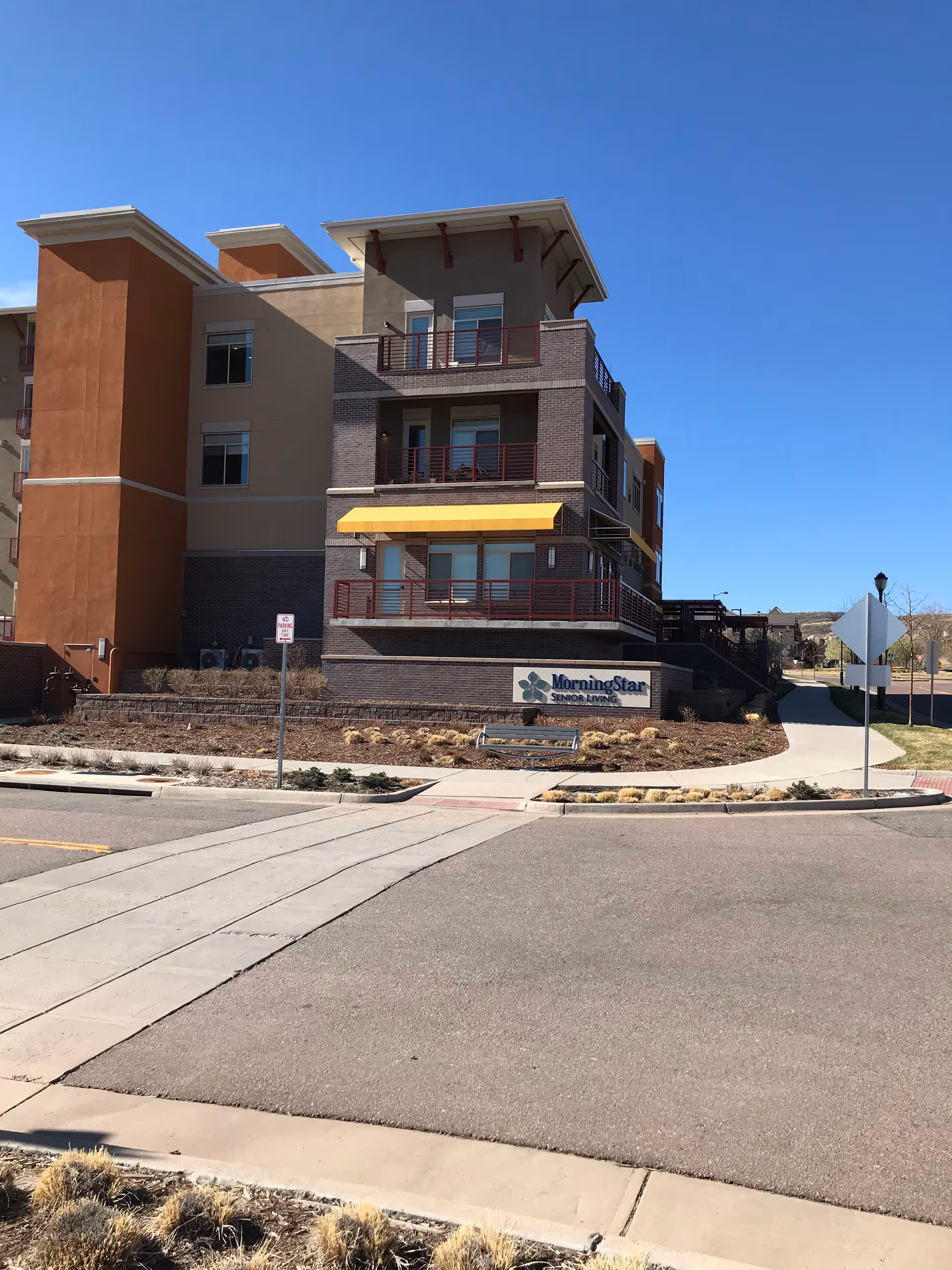 Multi-story MorningStar Senior Living building with balconies and a sign near the entrance.