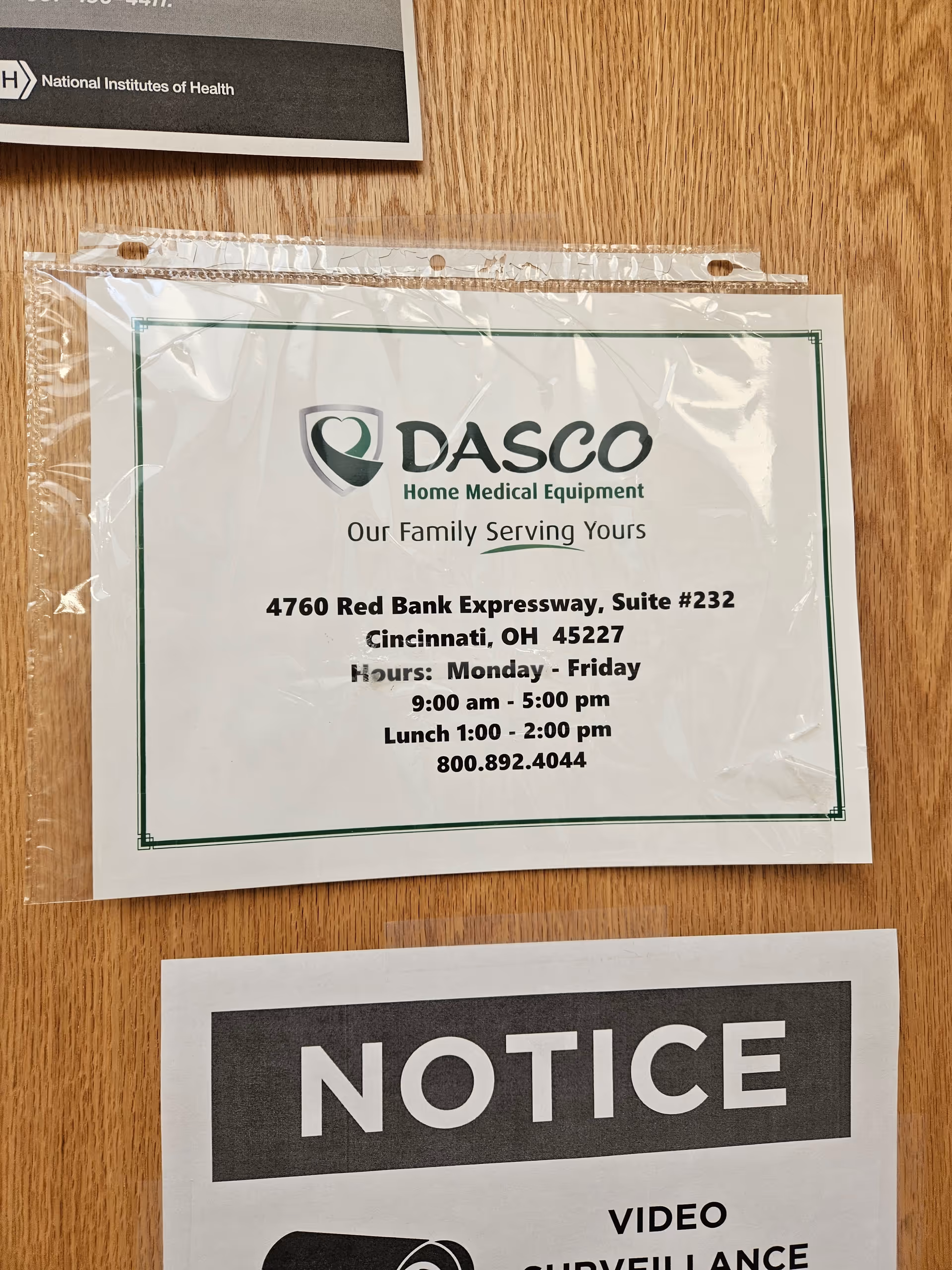 DASCO Home Medical Equipment notice posted on a wooden interior wall.