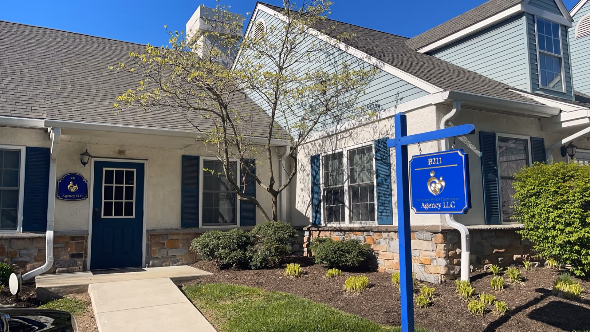 Exterior view of Genuine Heart Homecare Agency LLC building with blue door and sign.