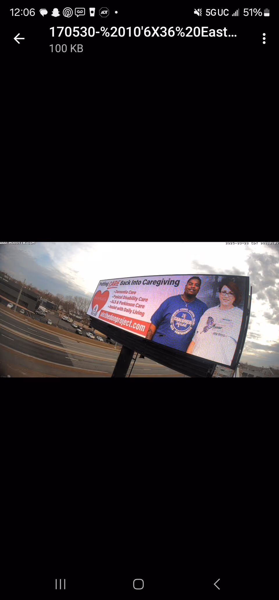 A roadside outdoor billboard featuring two people advertising caregiving services.
