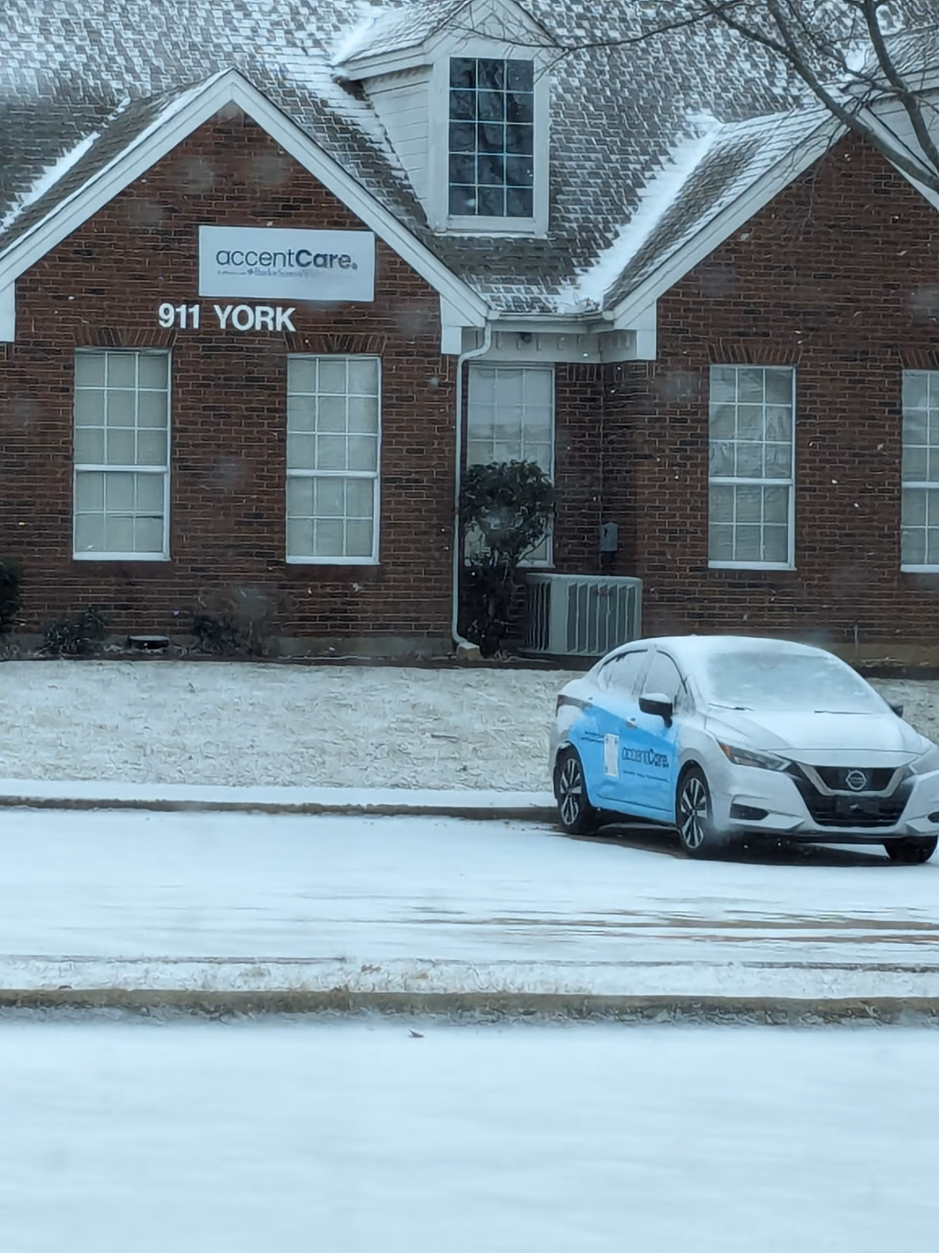 Exterior view of AccentCare Home Health building affiliated with Baylor Scott & White in snowy weather.