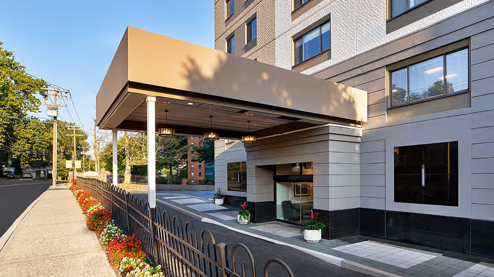 Exterior view of Atria Stamford entrance with a covered drop-off area.