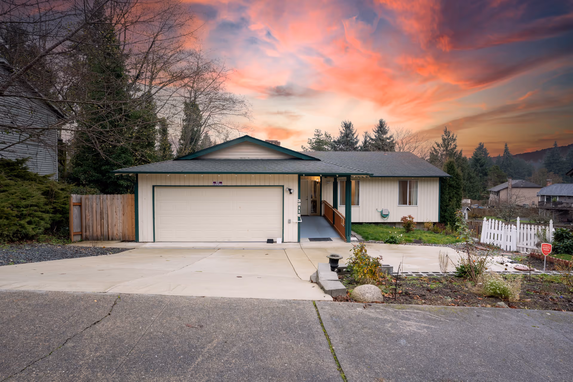 Front exterior of a single-story home with a two-car garage and wheelchair ramp.