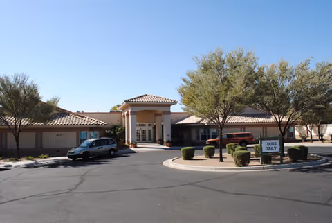 Front exterior of Brookdale North Glendale senior living center with driveway and parked cars.