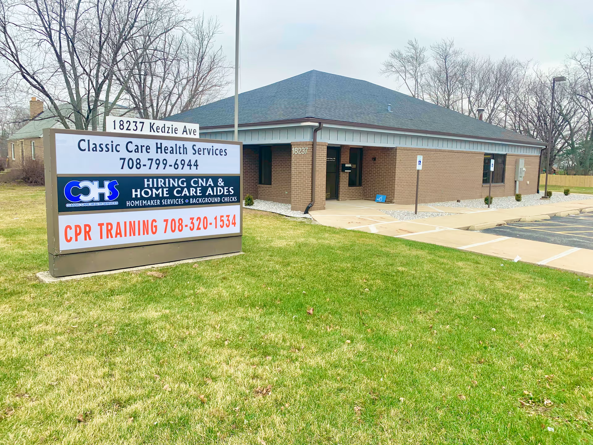 Exterior view of Classic Care Health Services building with a large sign on a grassy lawn.