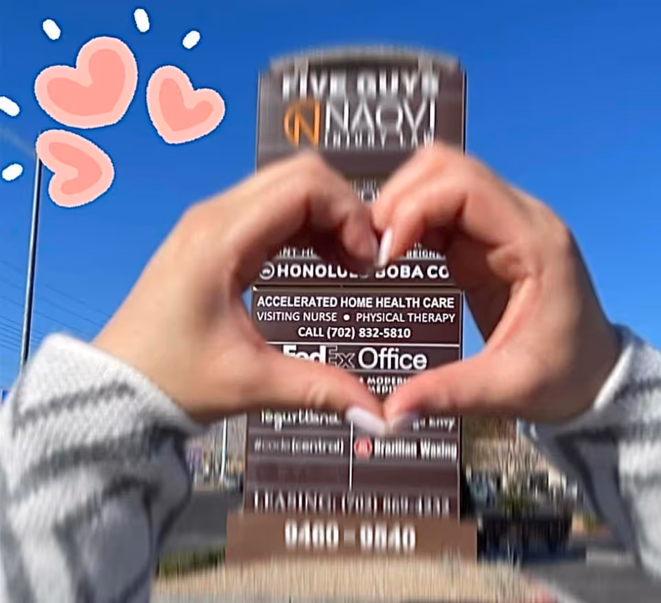 Hands form a heart around a sign for Accelerated Home Health Care outdoors