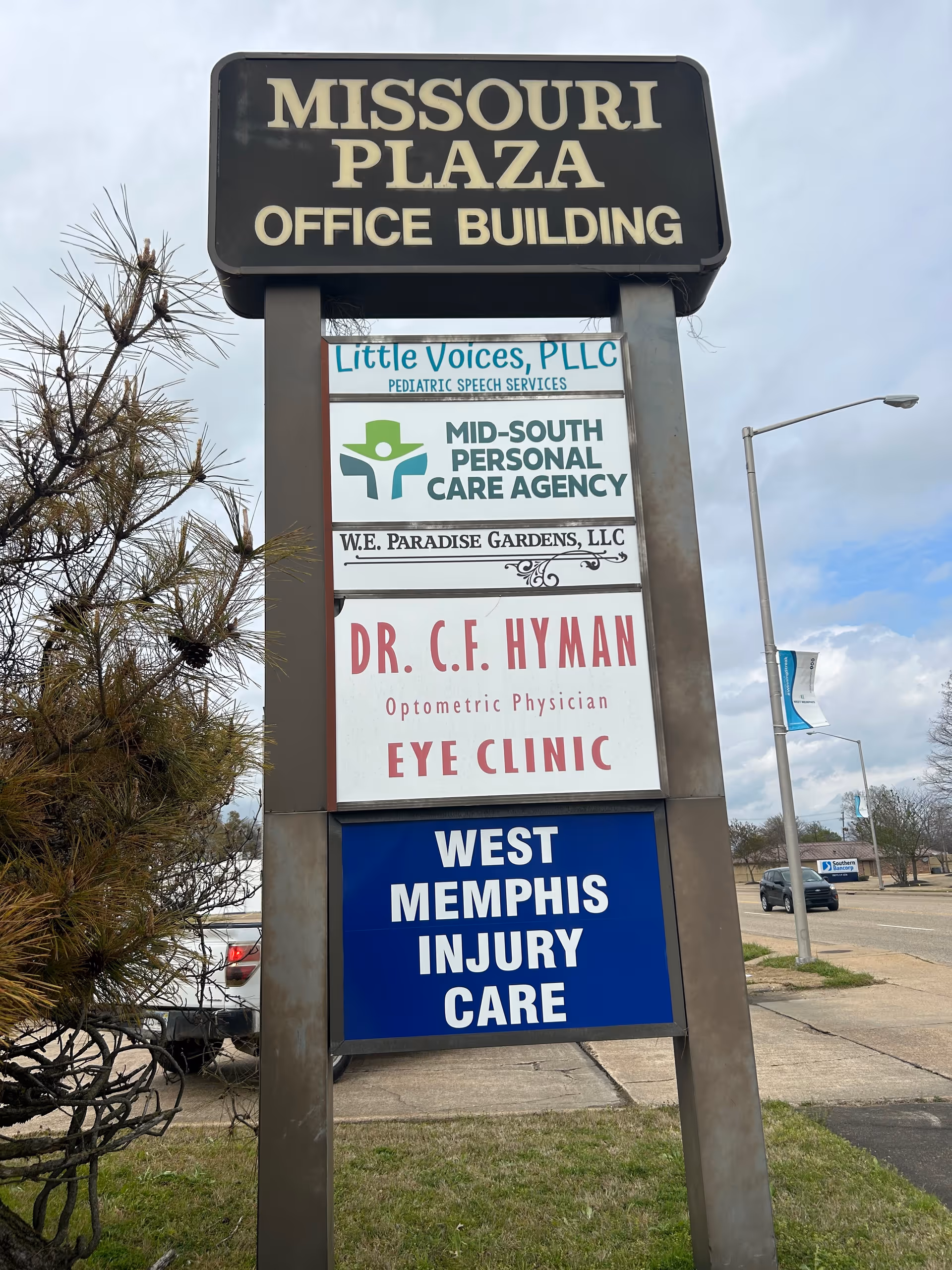 Tall outdoor signboard outside Missouri Plaza Office Building listing Mid-South Personal Care Agency