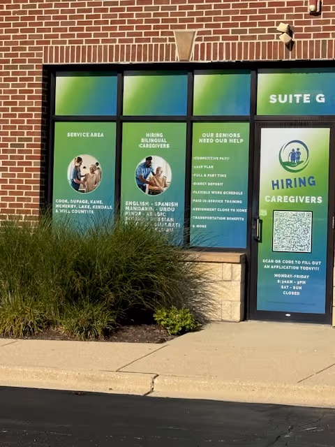 Exterior view of a senior care facility with hiring signs.