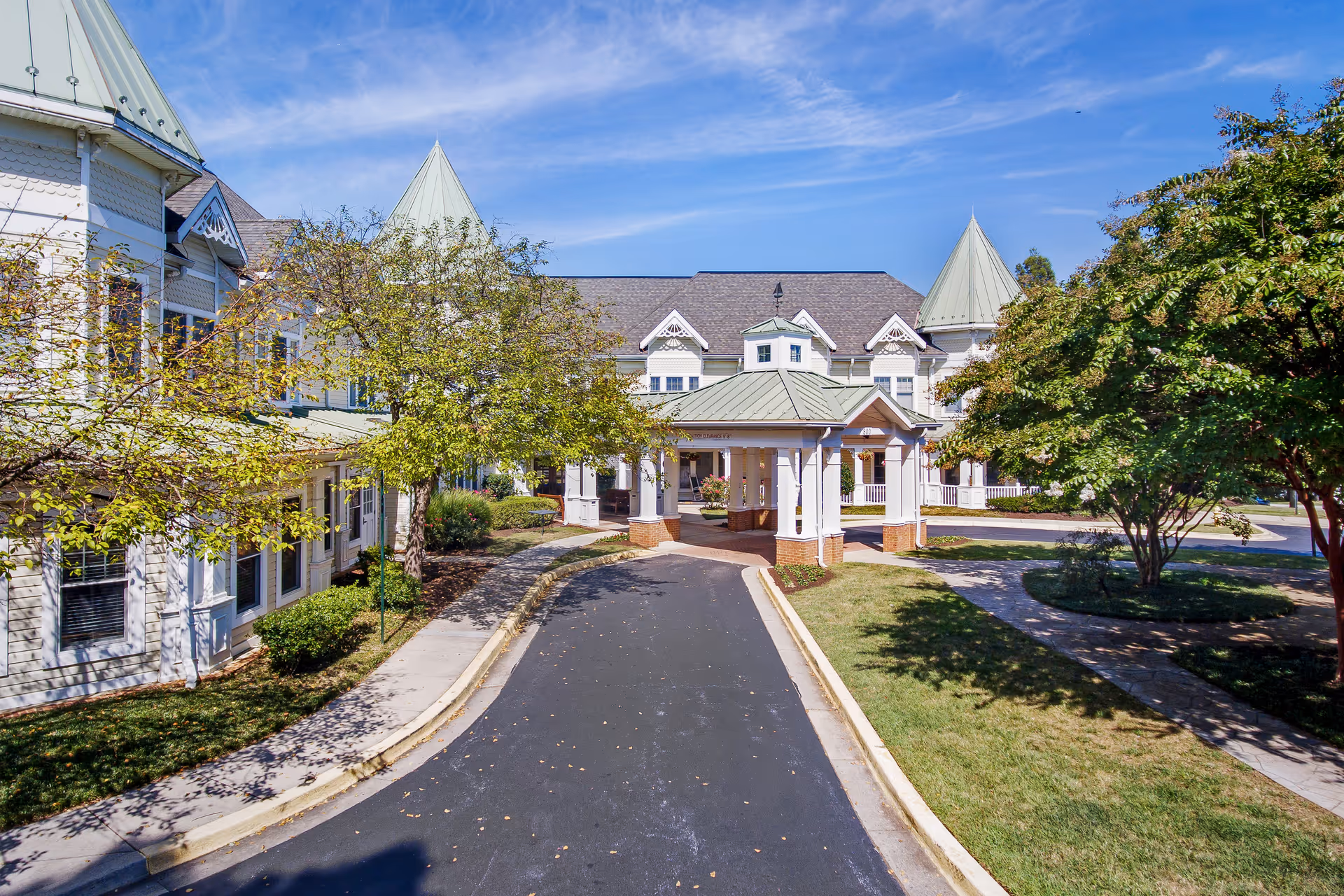 Exterior view of Sunrise of Annapolis with driveway, entrance, and surrounding trees.