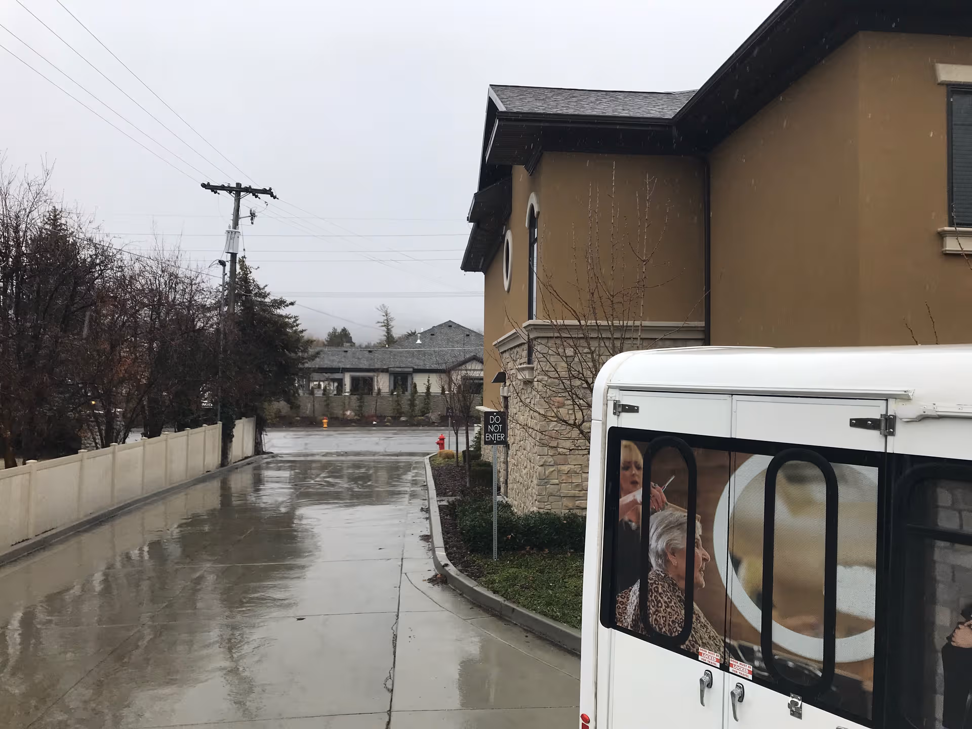 Exterior view of The Ridge Cottonwood building with a parked bus by the entrance.