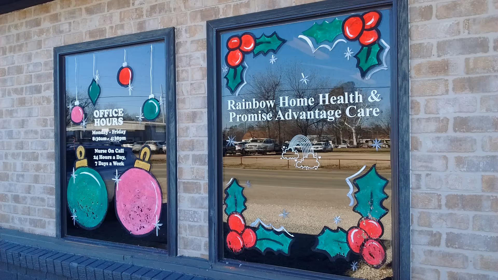 Brick building exterior with holiday window art advertising Rainbow Home Health and Promise Advantage Care.