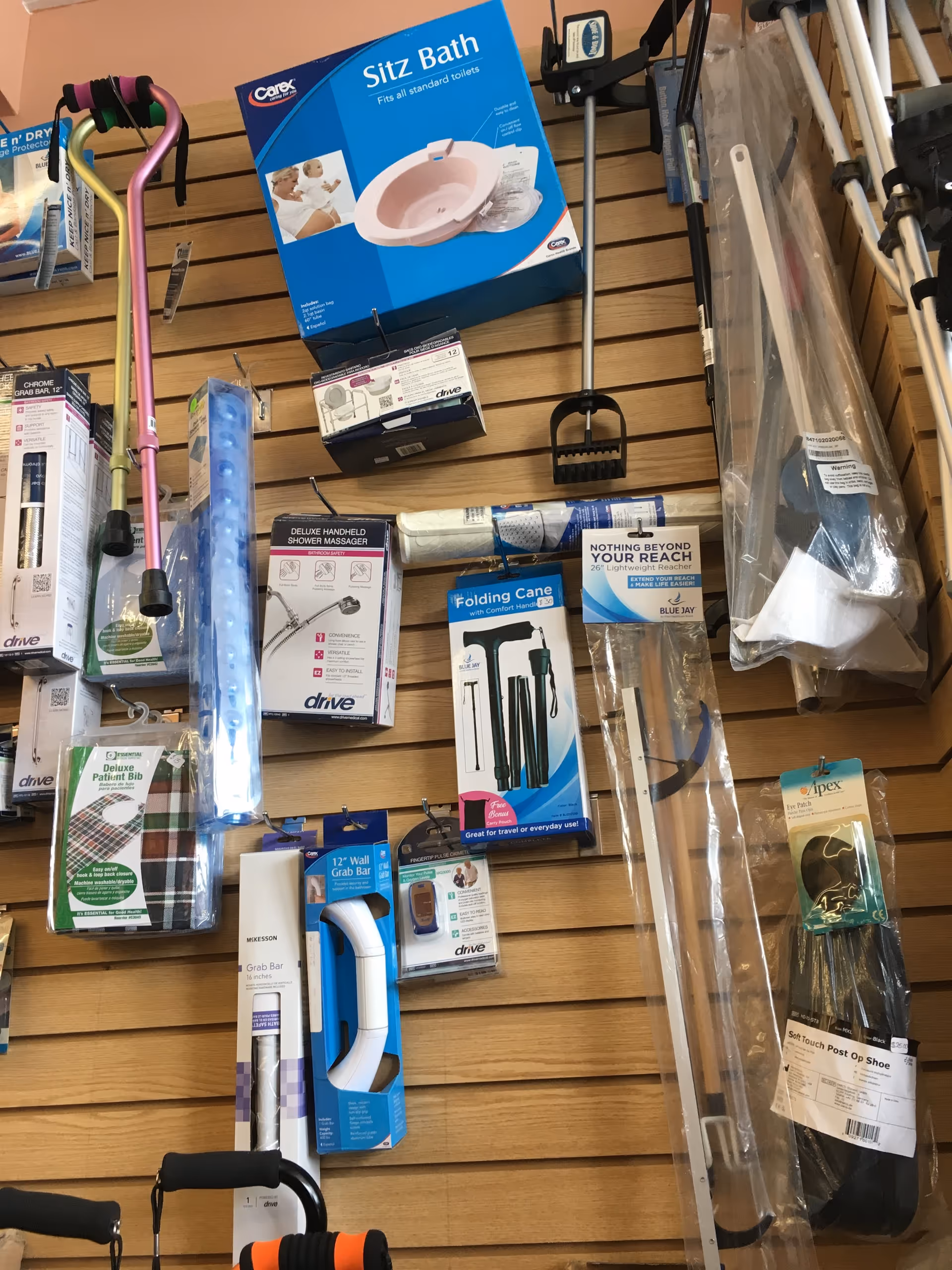 Wall display of medical equipment and accessories in a store, including a Sitz Bath box.