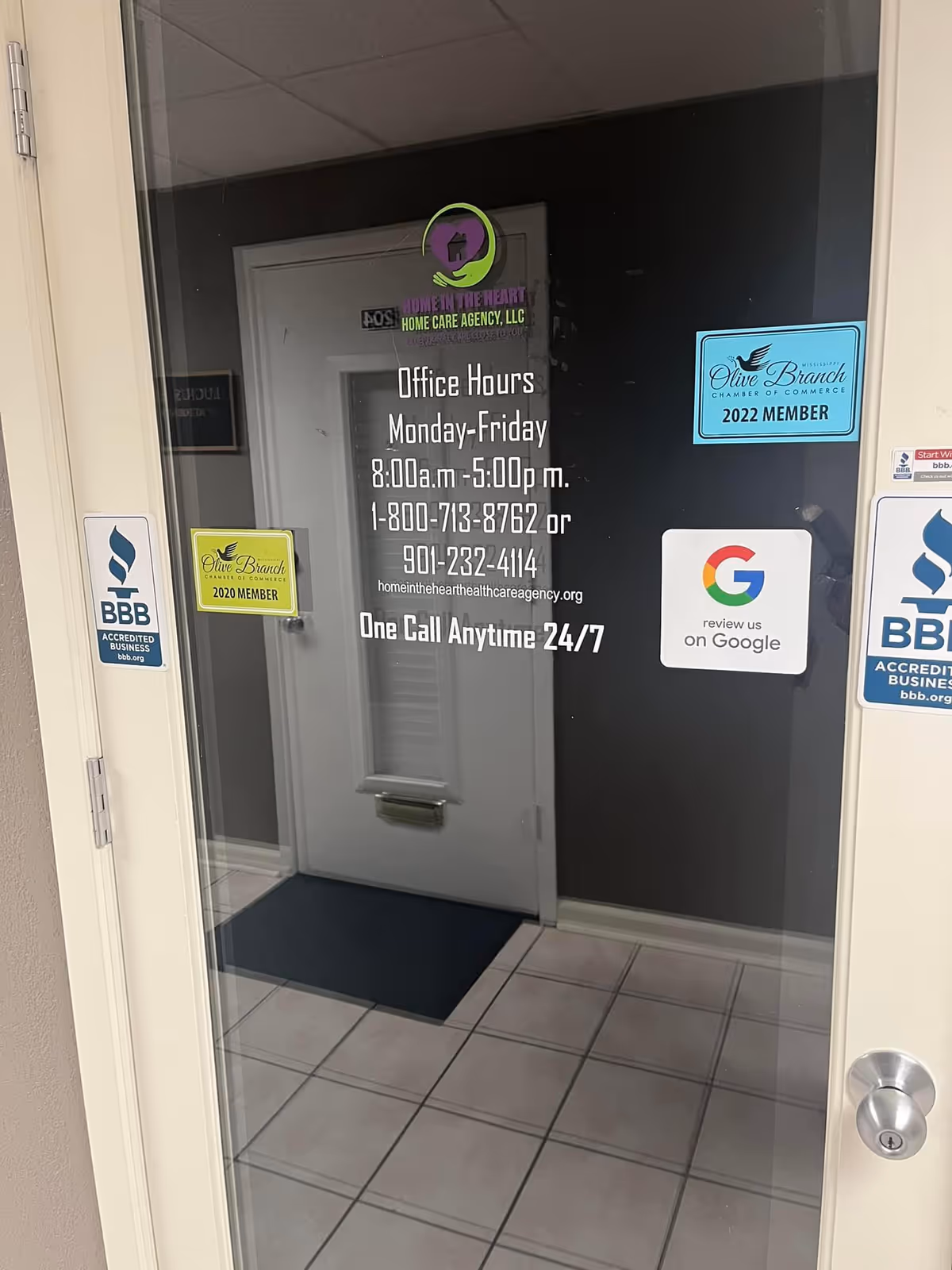 Glass entrance door for Home in the Heart Home Care Agency with signs
