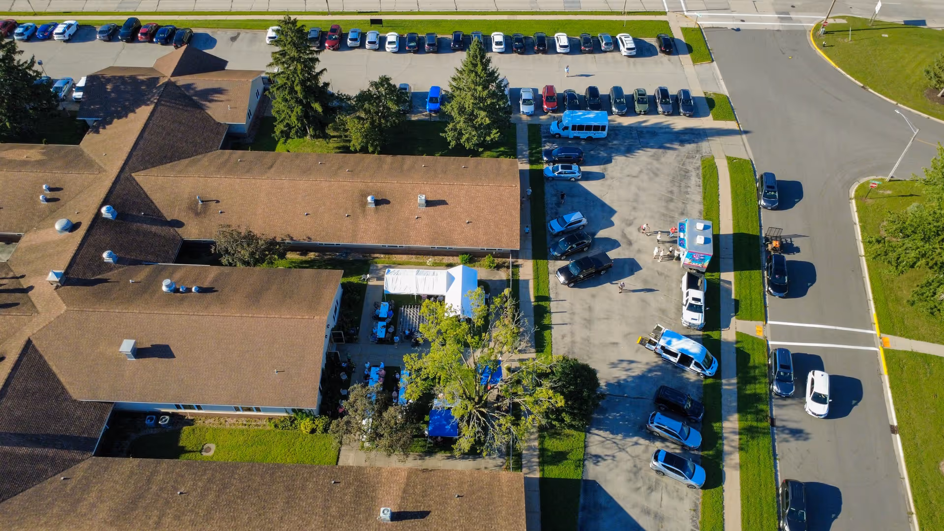 Aerial view of Onalaska Care Center's brown-roofed buildings and surrounding parking lot.
