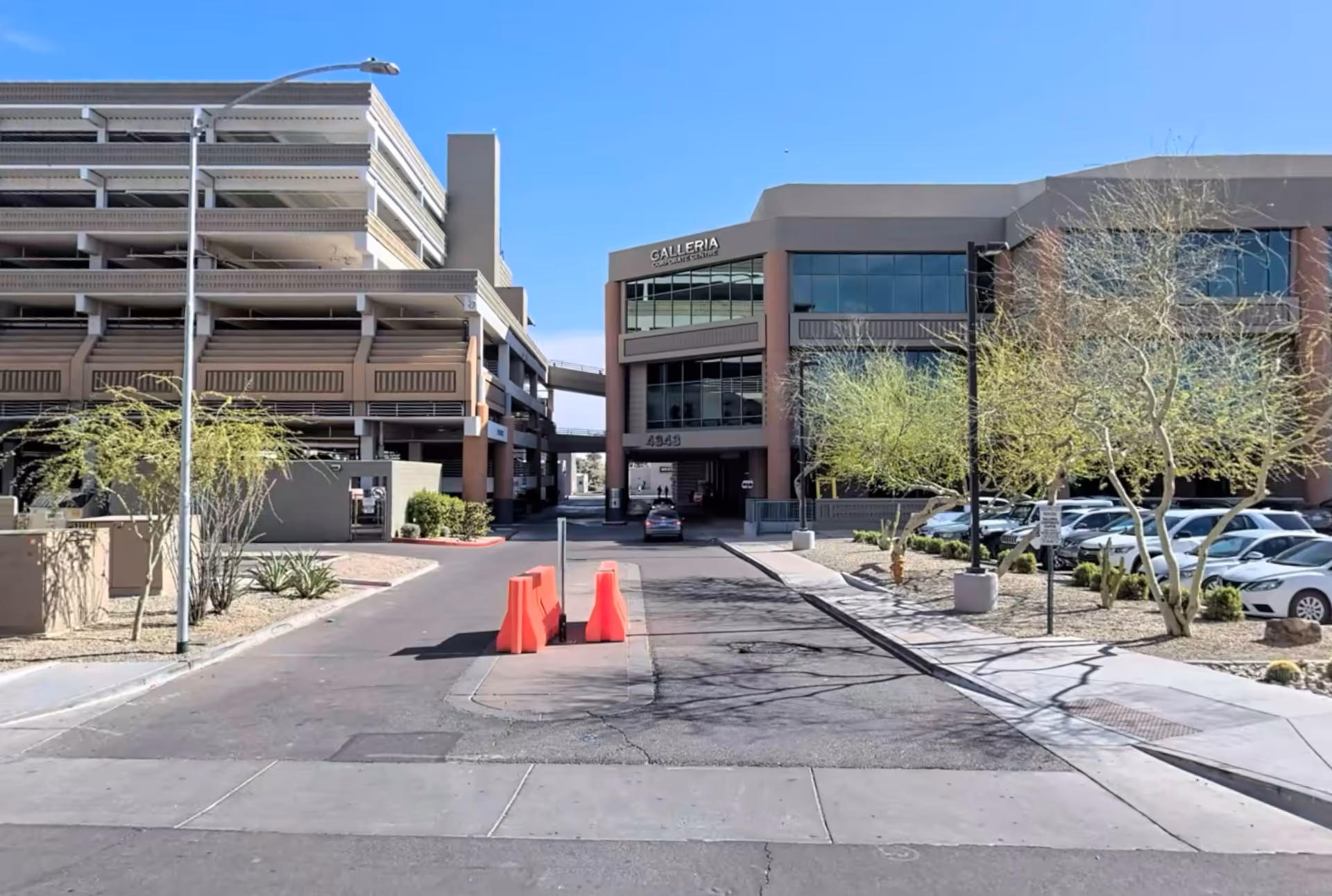 Exterior view of Amity Health Group facility with parking garage and entrance.