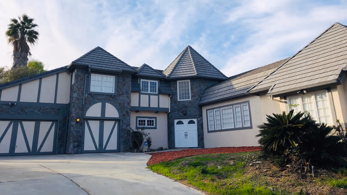 Front exterior view of Ohana Senior Assisted Living building with stone facade and driveway
