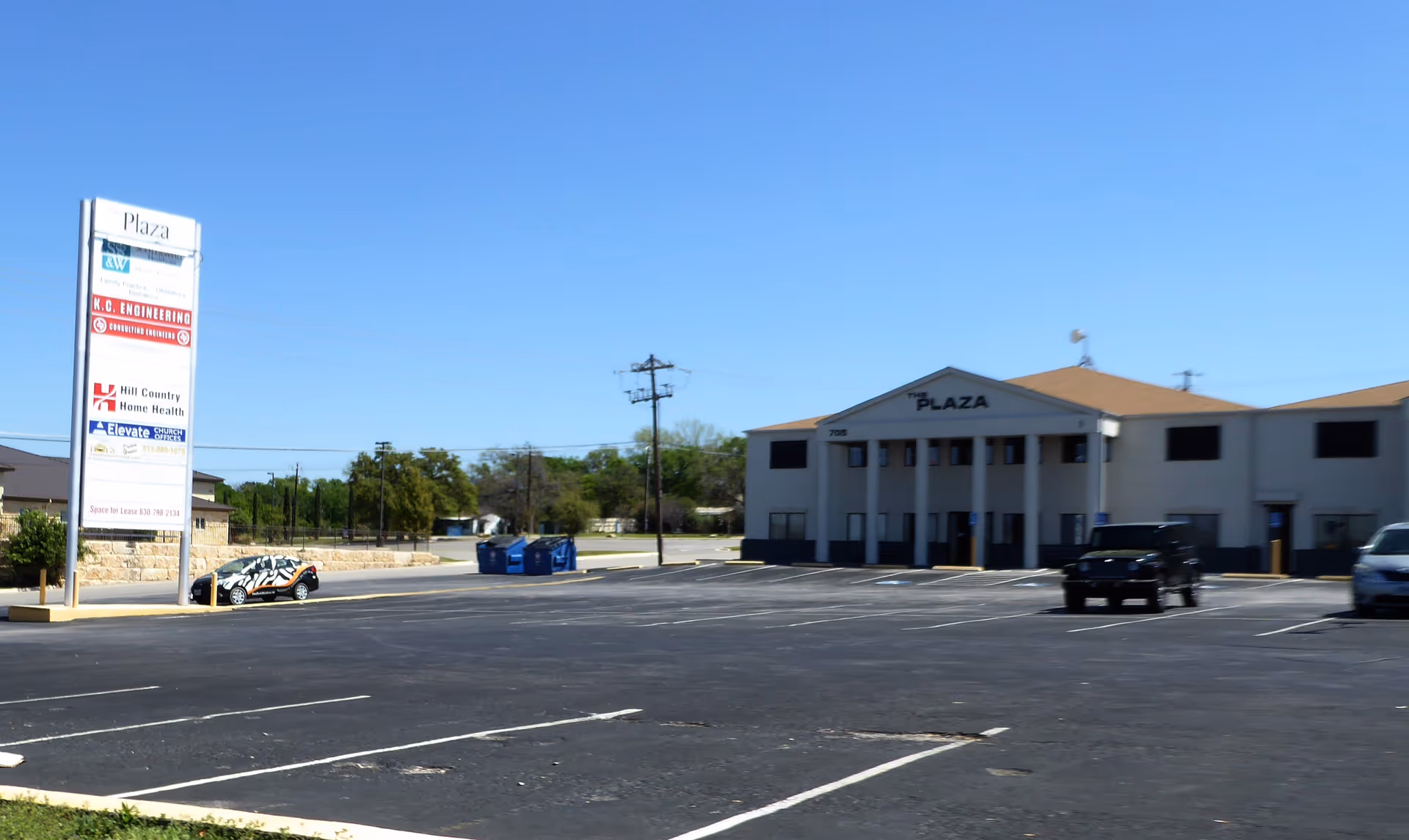 Exterior view of Hill Country Home Health facility with parking lot and sign