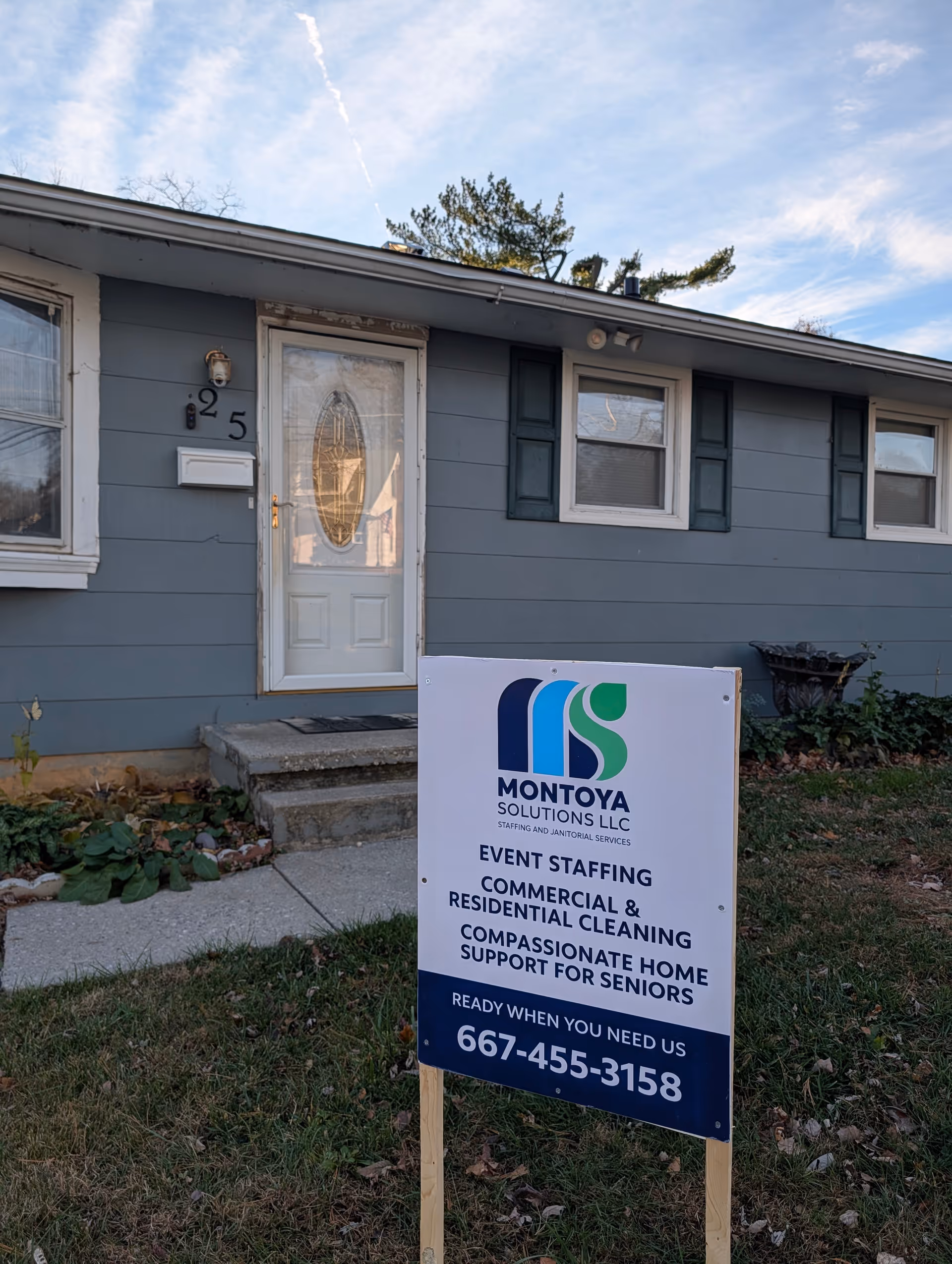 Blue single-story house with Montoya Solutions sign in the front yard.