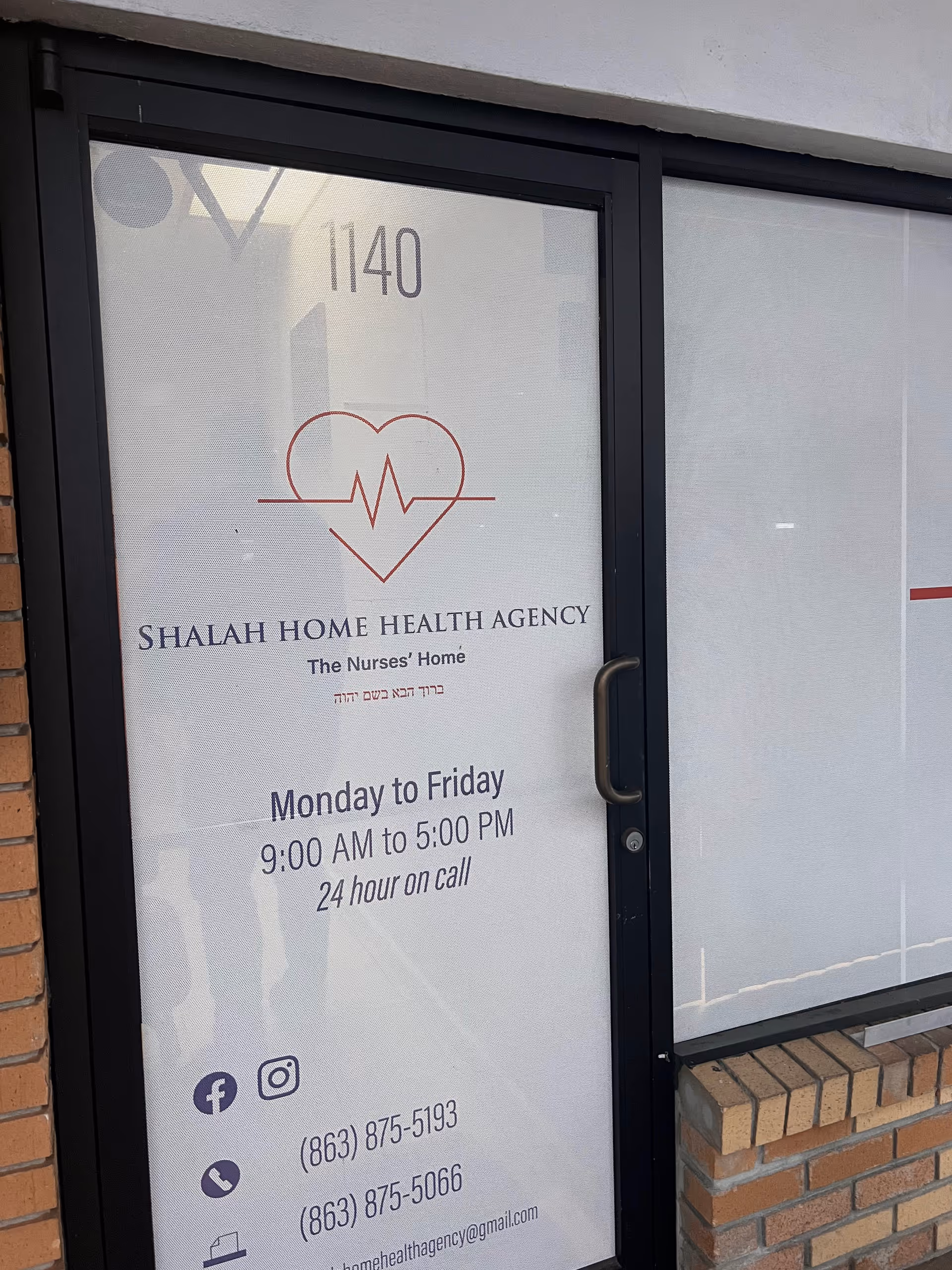 Glass door storefront with Shalah Home Health Agency sign, hours, and social icons.