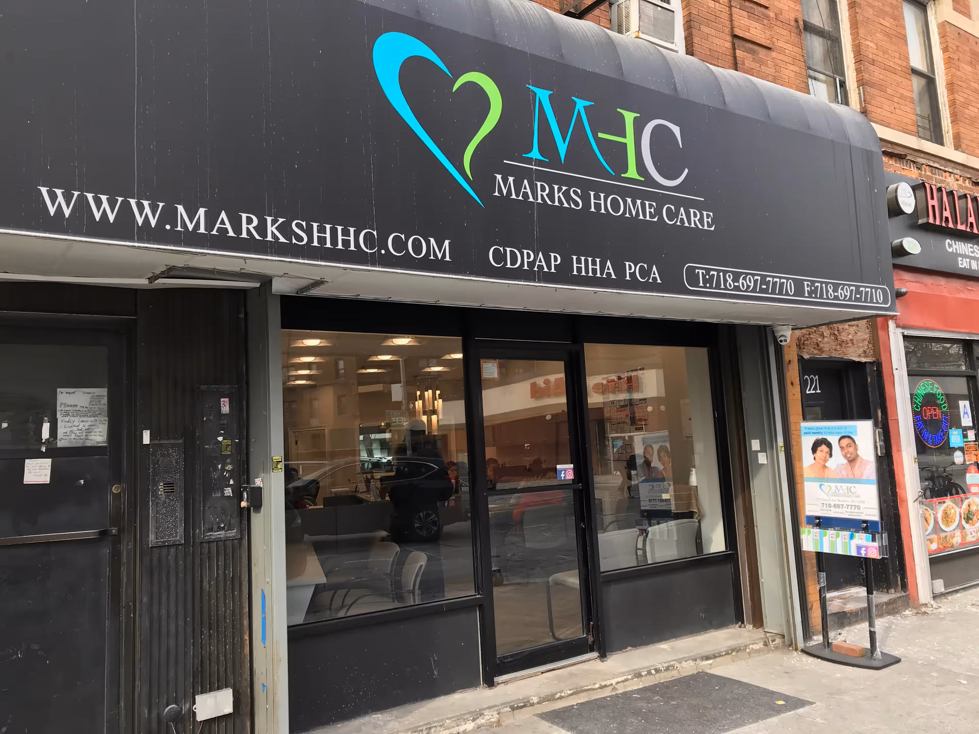 Storefront of Marks Home Care with a large black awning and glass entrance.