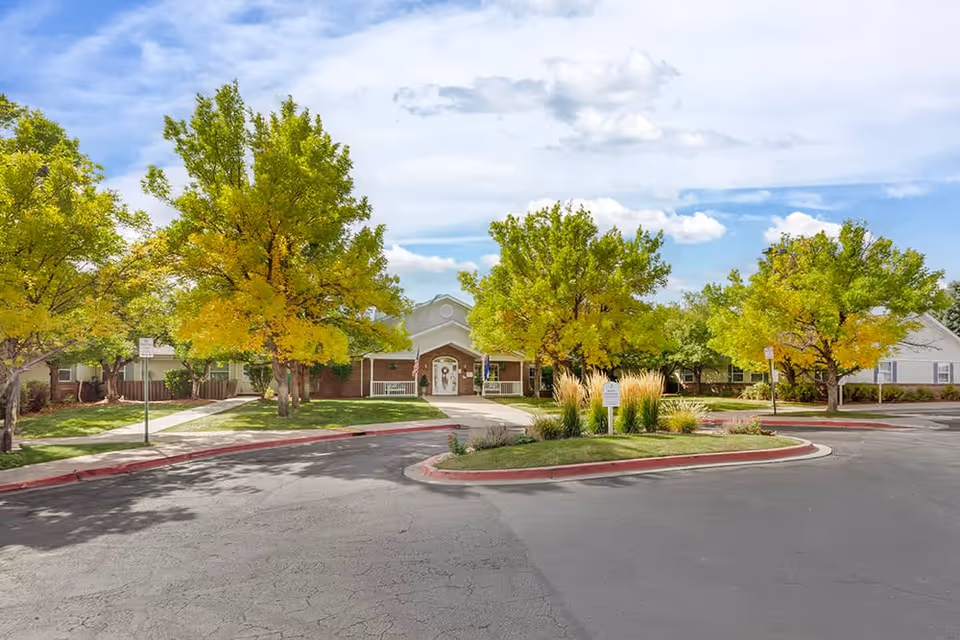 Brookdale Fisher's Landing exterior with a circular driveway and trees.
