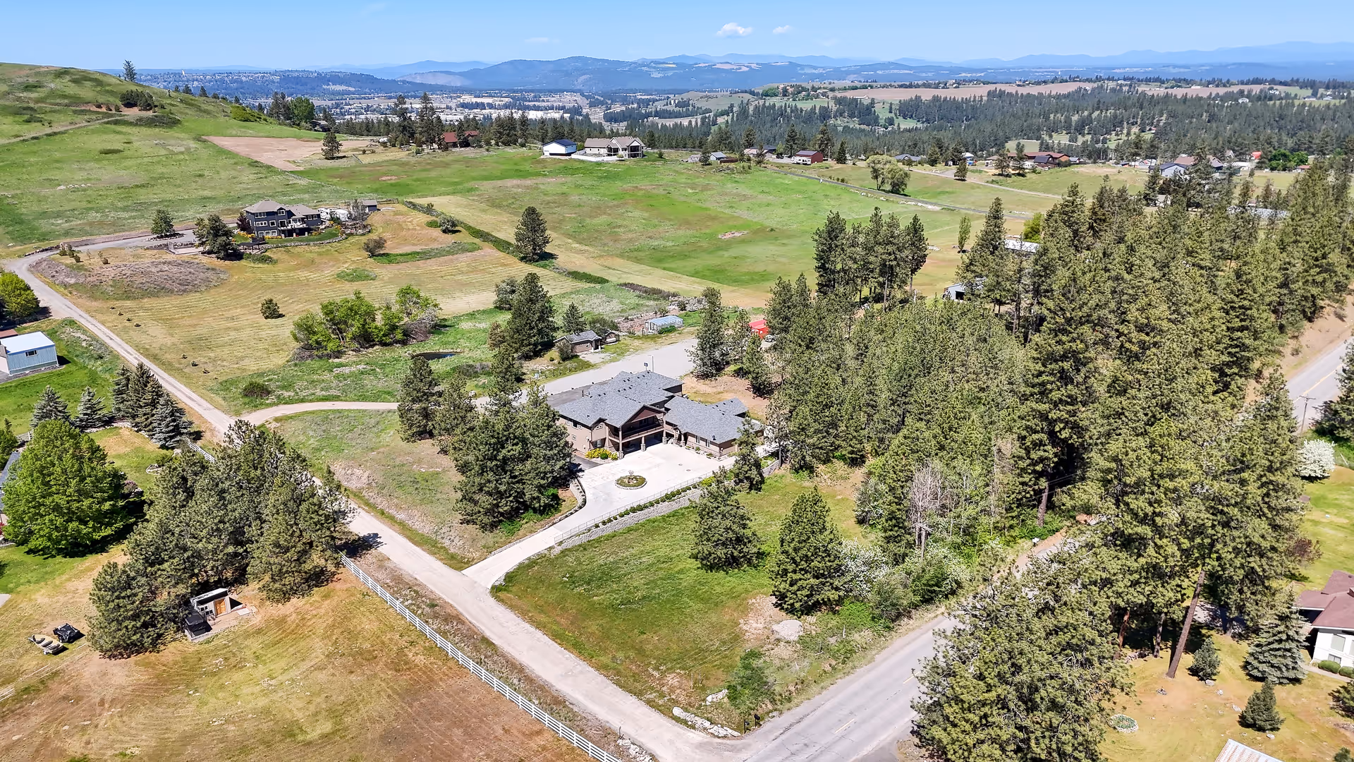 Aerial view of a rural senior living campus with a central building and surrounding trees