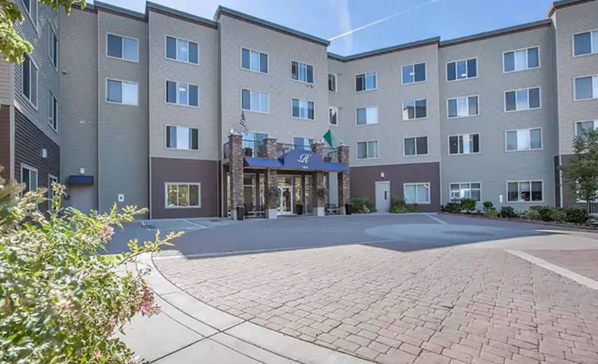 Exterior view of Regency Newcastle facility with a multi-story building and entrance.